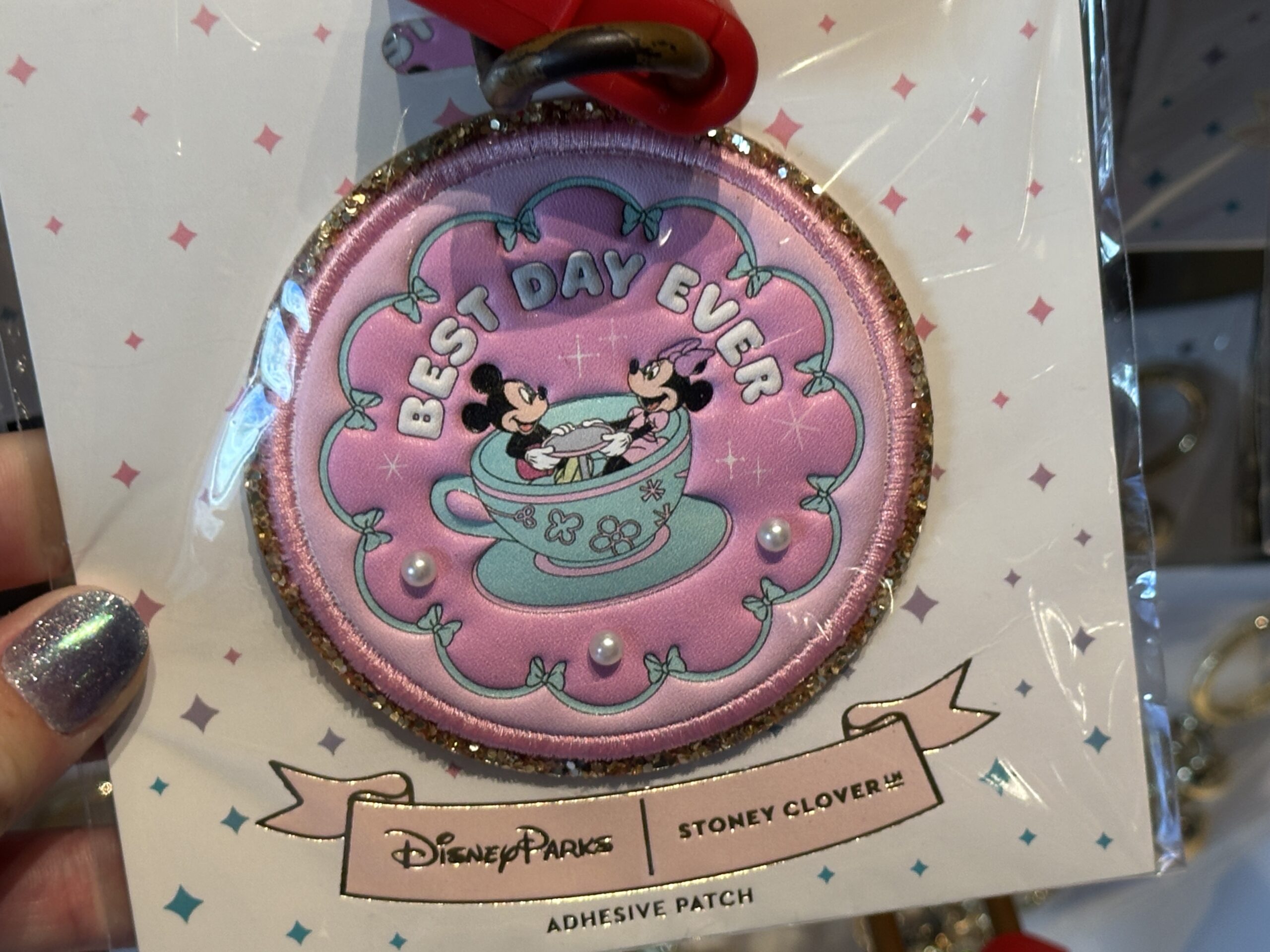The same tea cup artwork is on this circular patch against a pink background with aqua ribbons. "Best Day Ever" is above Mickey and Minnie. Three pearls are below.