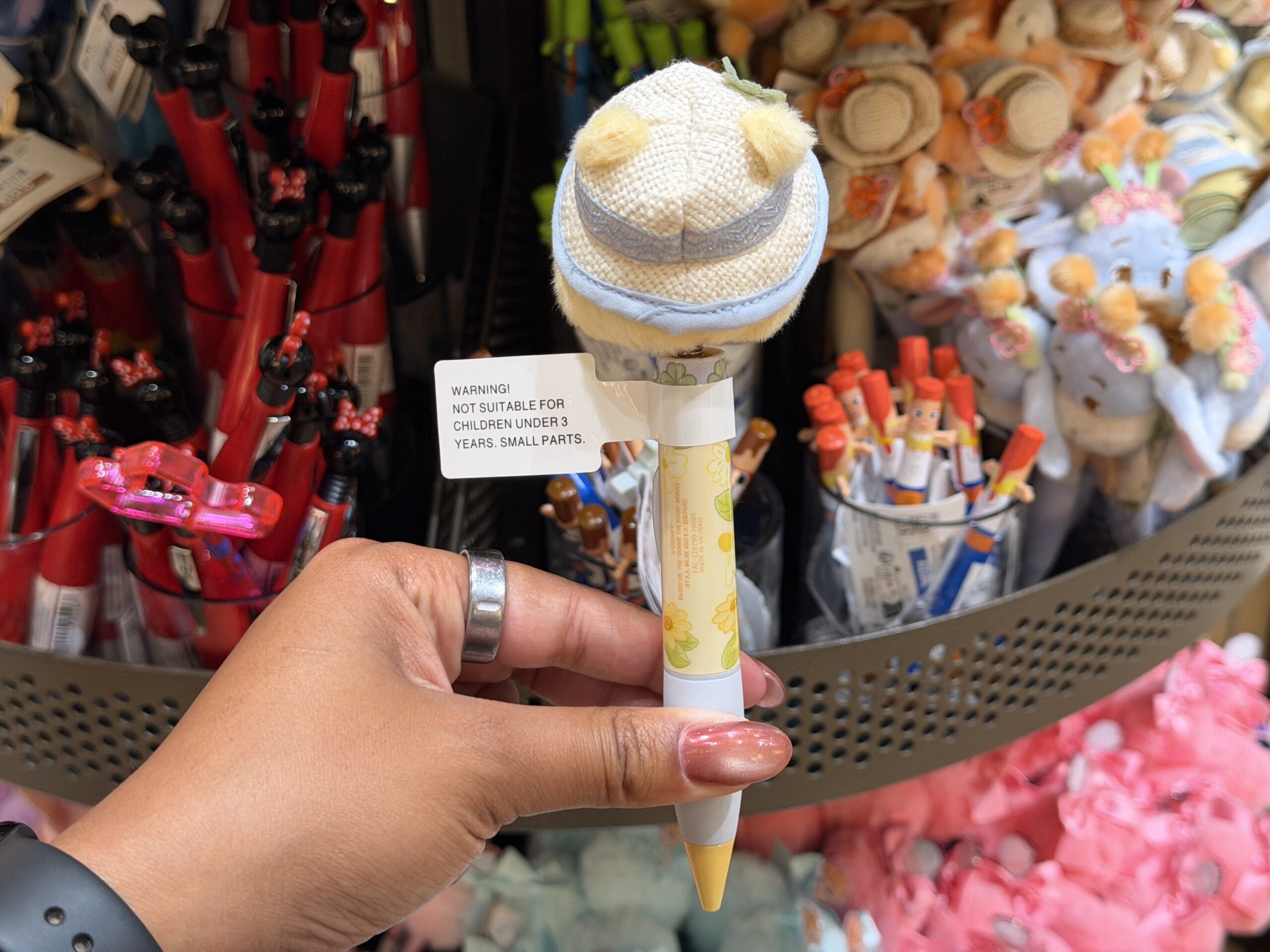 The pen barrel features yellow floral artwork, with a white oval nameplate reading “Pooh” in yellow lettering. The pen tip is yellow, matching Pooh’s color scheme.