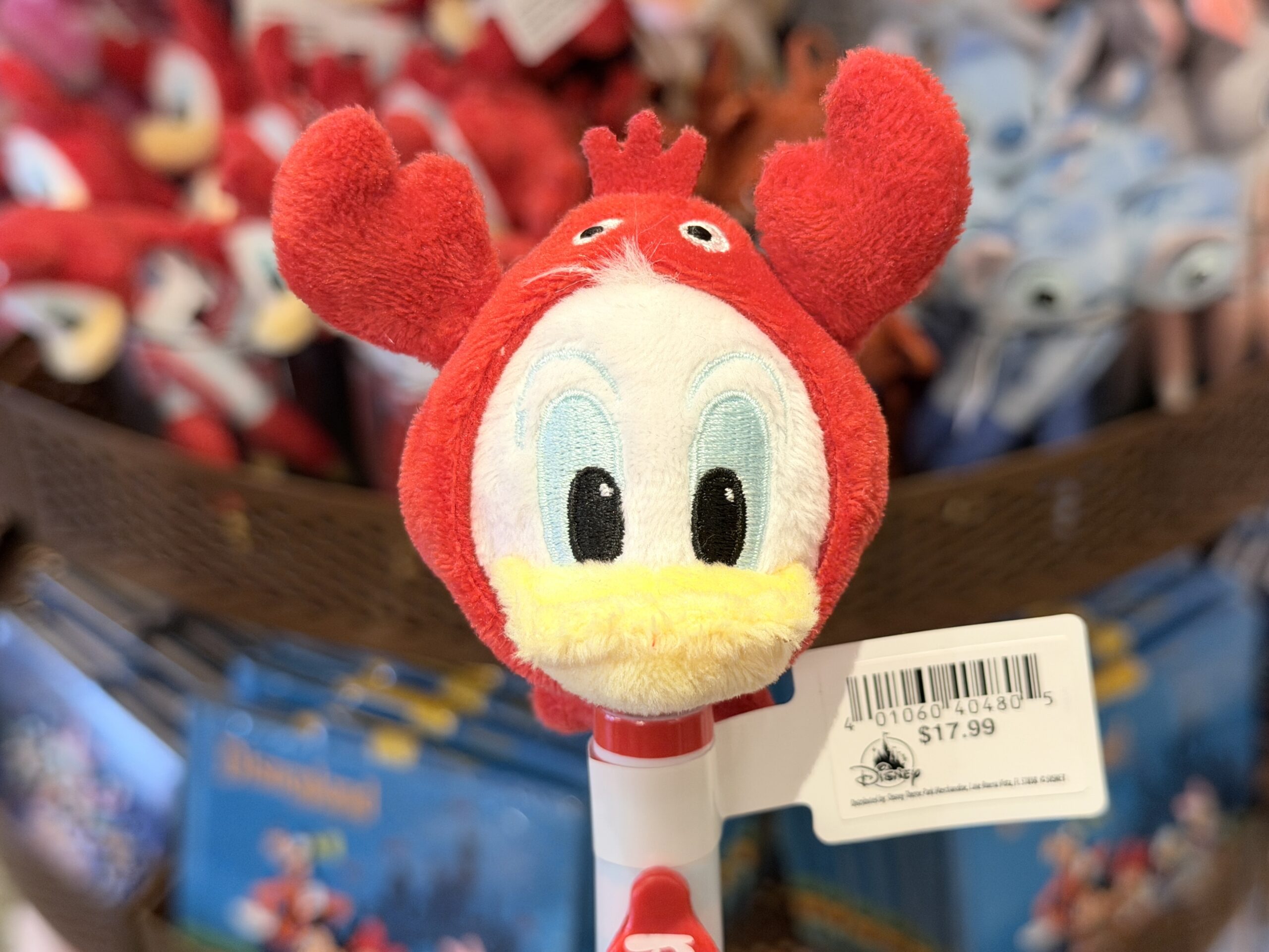 The pen barrel is red and white, with Donald’s name printed vertically on a red nameplate. A yellow pen tip completes the look.
