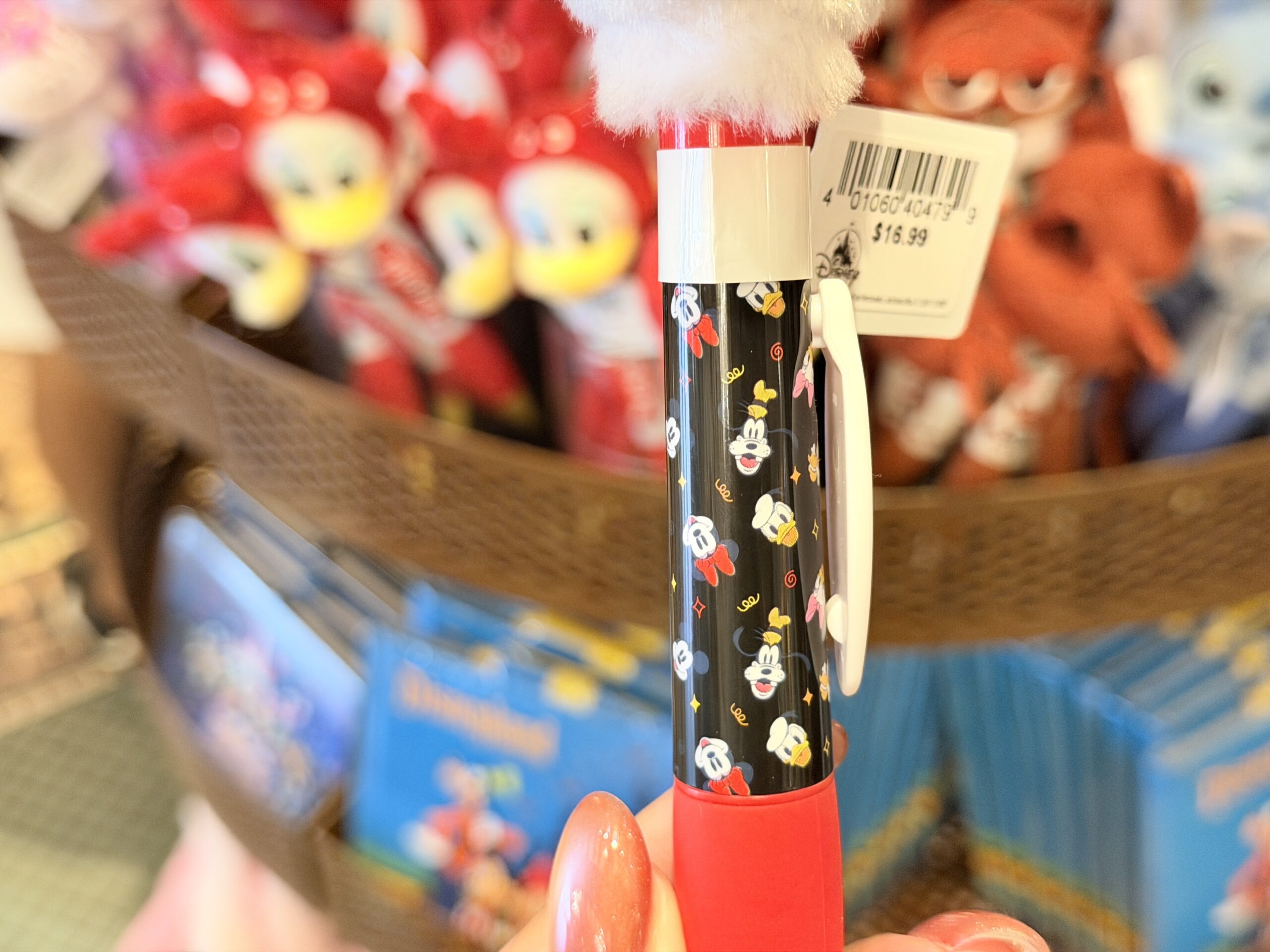 The barrel is red, black, and white, with small Mickey icon artwork and a white nameplate reading “Mickey Mouse” in yellow script. The red lower barrel and white pen tip give it a classic Mickey-inspired color scheme.