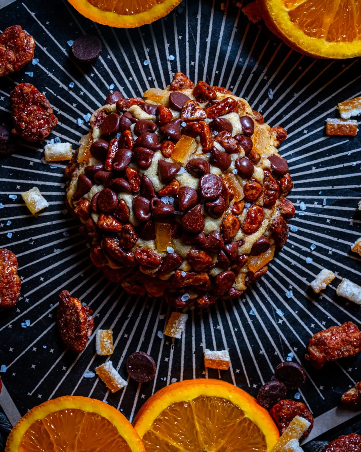 This vanilla bean cookie is infused with orange essence and has dark chocolate chips mixed in. It is then covered in pecan pralines and candied orange peel.