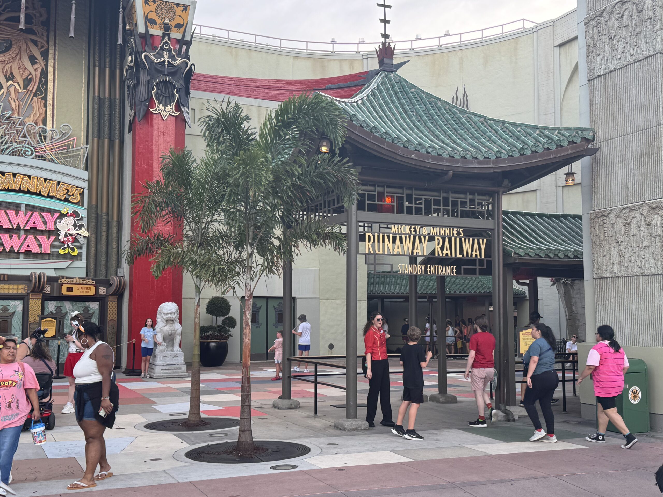 The replacements restore some symmetry to the theater’s forecourt while framing views of the Mickey & Minnie’s Runaway Railway signage. The palms also complement the existing planters, sculpted shrubs, and Chinese guardian lion statues around the entrance.
