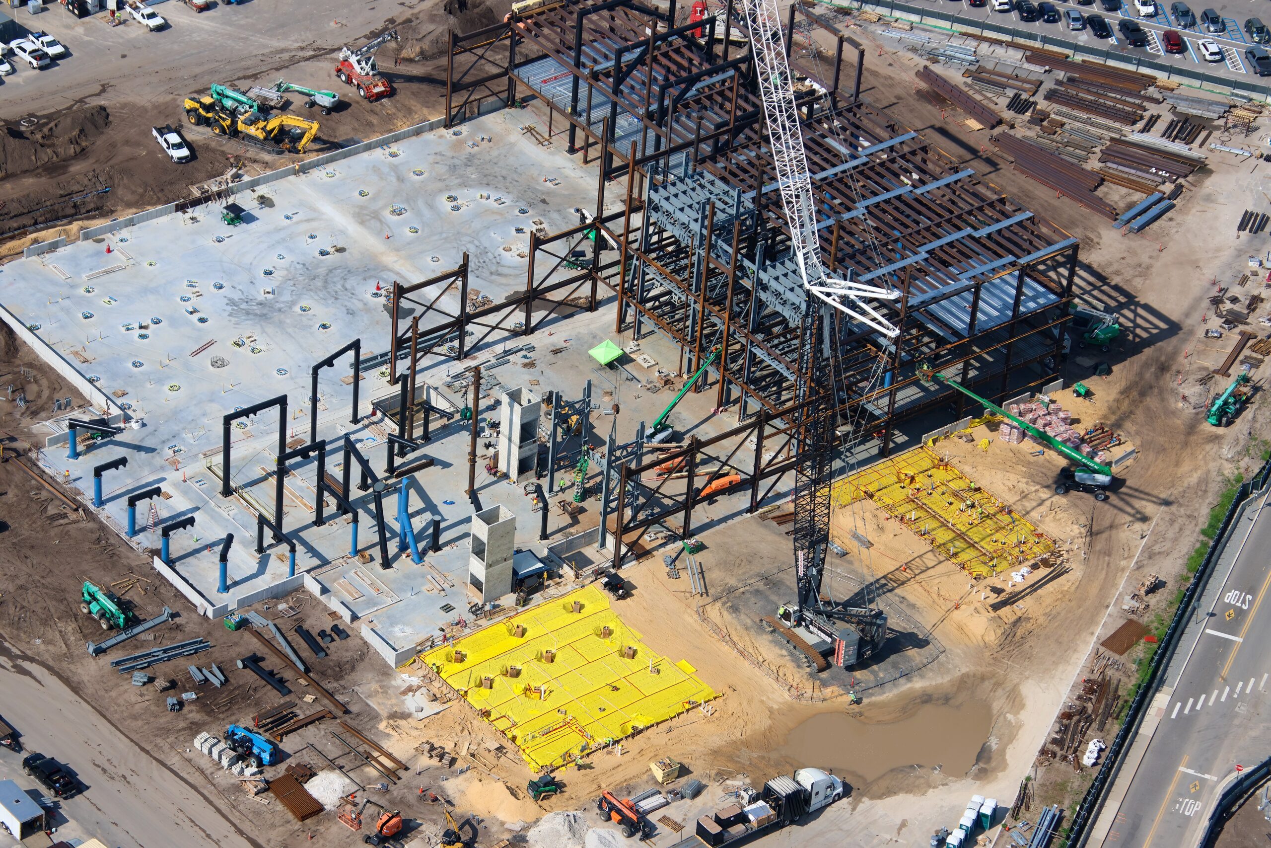 The doors are beginning to fall into place at the upcoming Monsters, Inc. roller coaster, as new aerial photos reveal progress on the attraction’s construction.