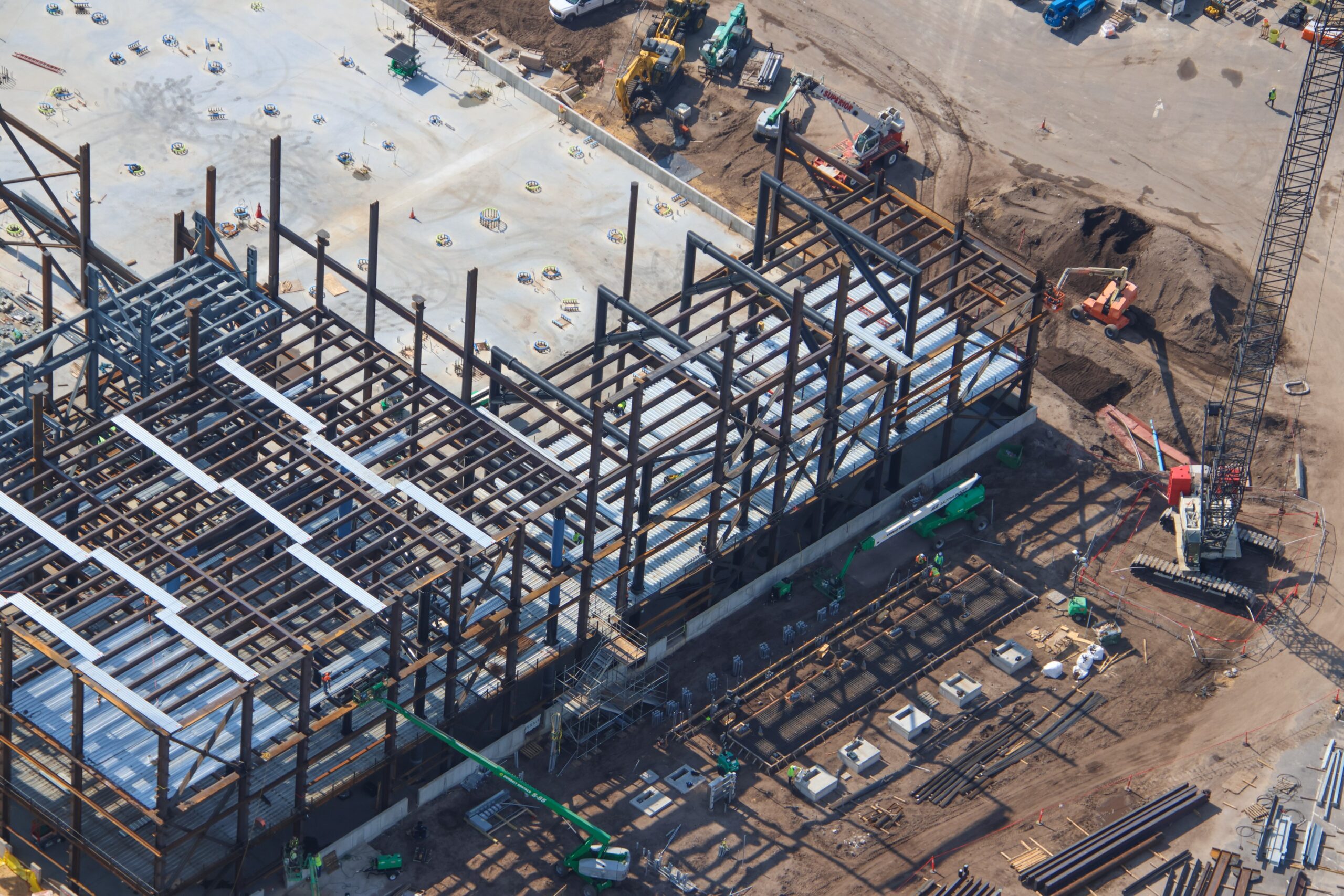The doors are beginning to fall into place at the upcoming Monsters, Inc. roller coaster, as new aerial photos reveal progress on the attraction’s construction.
