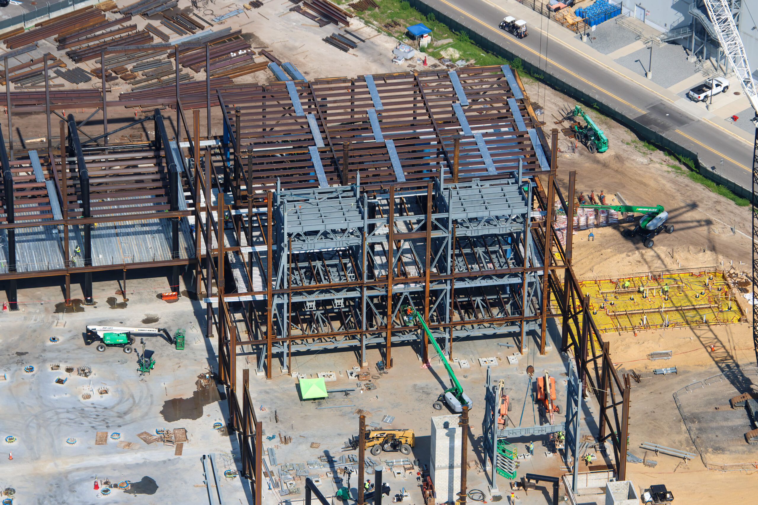 The doors are beginning to fall into place at the upcoming Monsters, Inc. roller coaster, as new aerial photos reveal progress on the attraction’s construction.