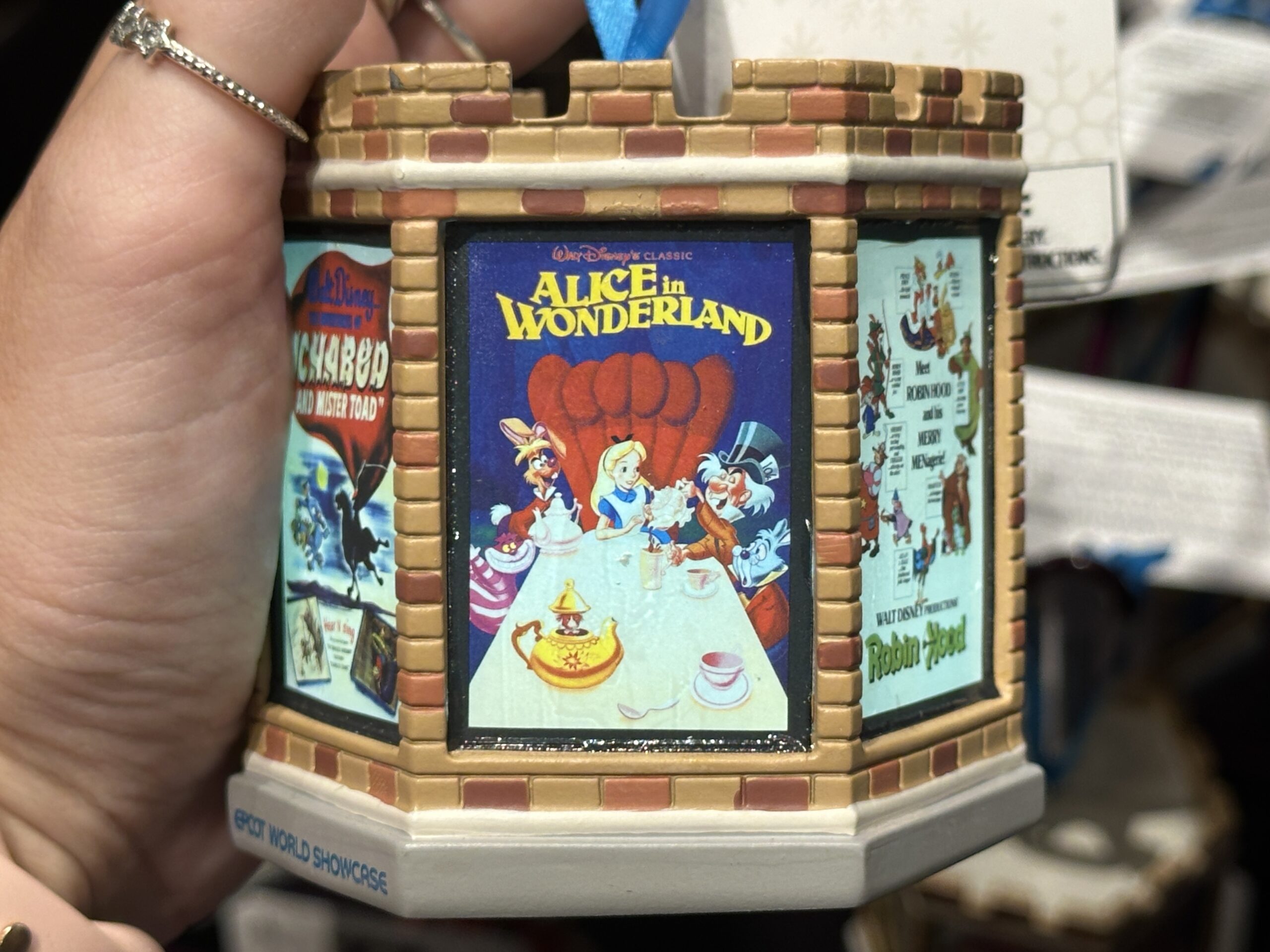 This six-sided, light-up ornament celebrates classic Disney films that took place in England. Each side has a different vintage poster from the film. These include Peter Pan, The Sword in the Stone, One Hundred and One Dalmatians, Icabod and Mister Toad, Alice in Wonderland, and Robin Hood.