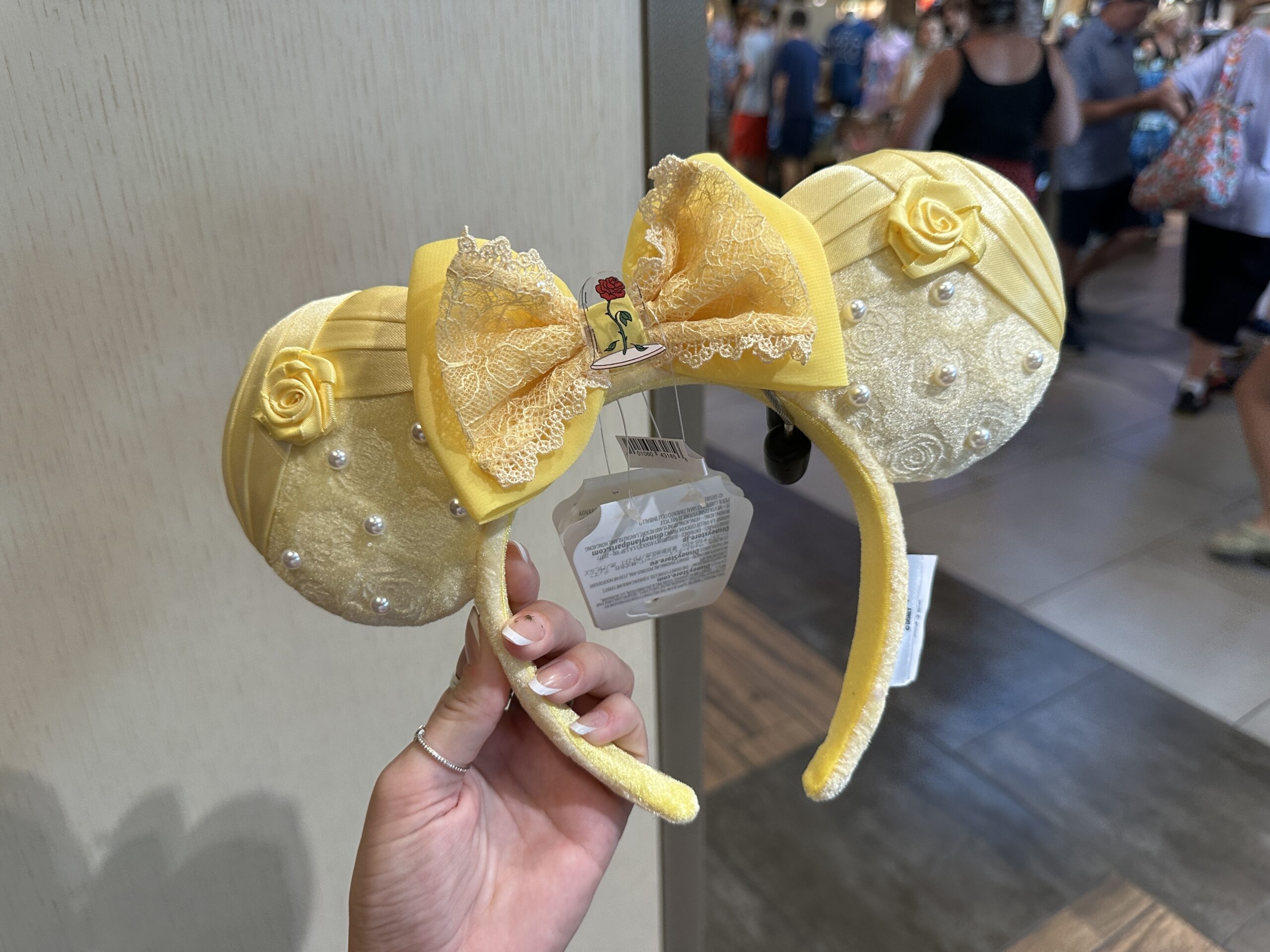 This bright yellow headband has a daisy yellow, velour-lined band with a matching first layer of bow. The secondary bow layer is detailed with white floral lace. This lace detailing matches each of the ears.