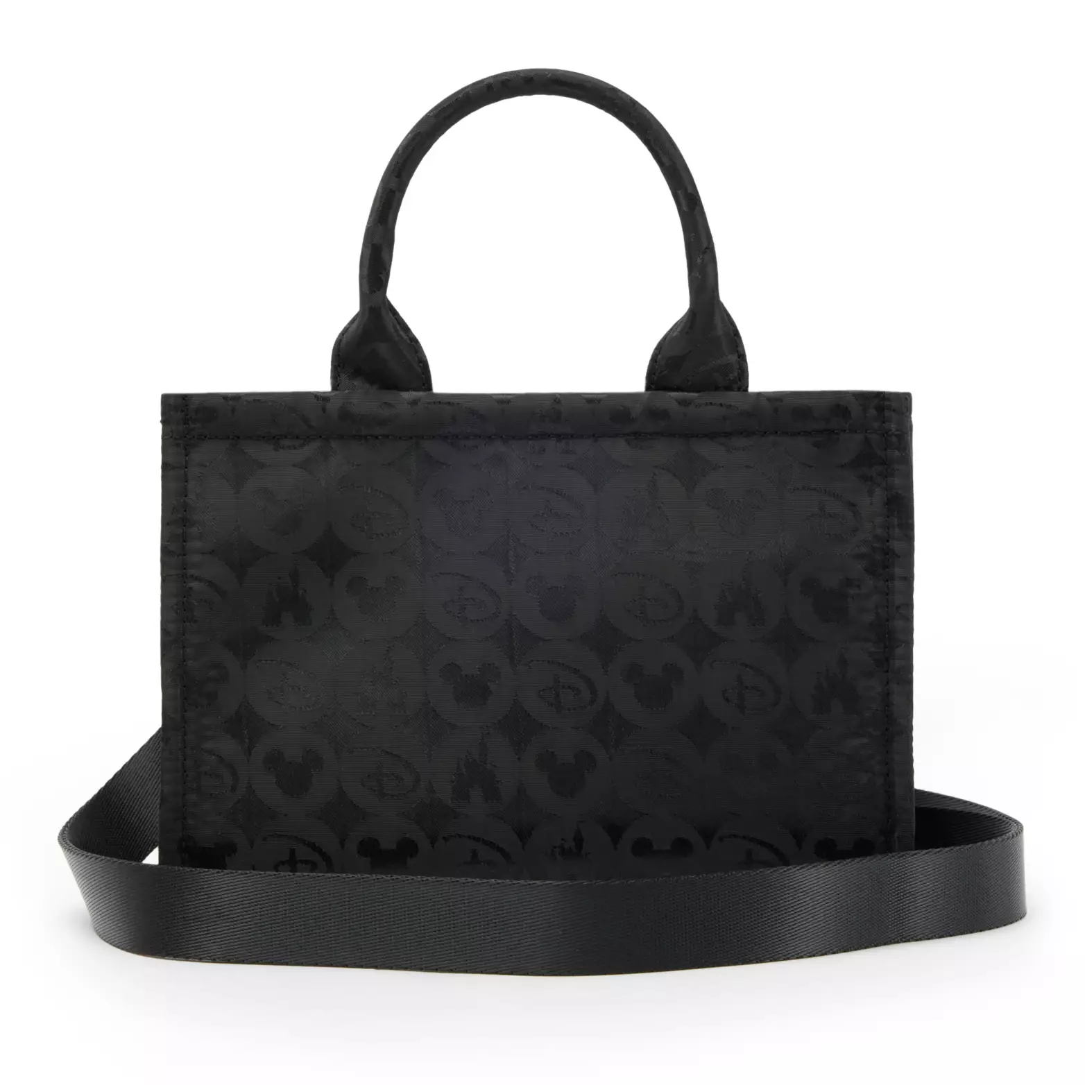 One of the bags you can purchase is a black tote with a repeating circular pattern with Disney iconography on it. The circles have a pattern of Disney “D”s, Mickey head icons, and castles. The zipper pull is silver-toned with a Disney “D” inside a castle.
