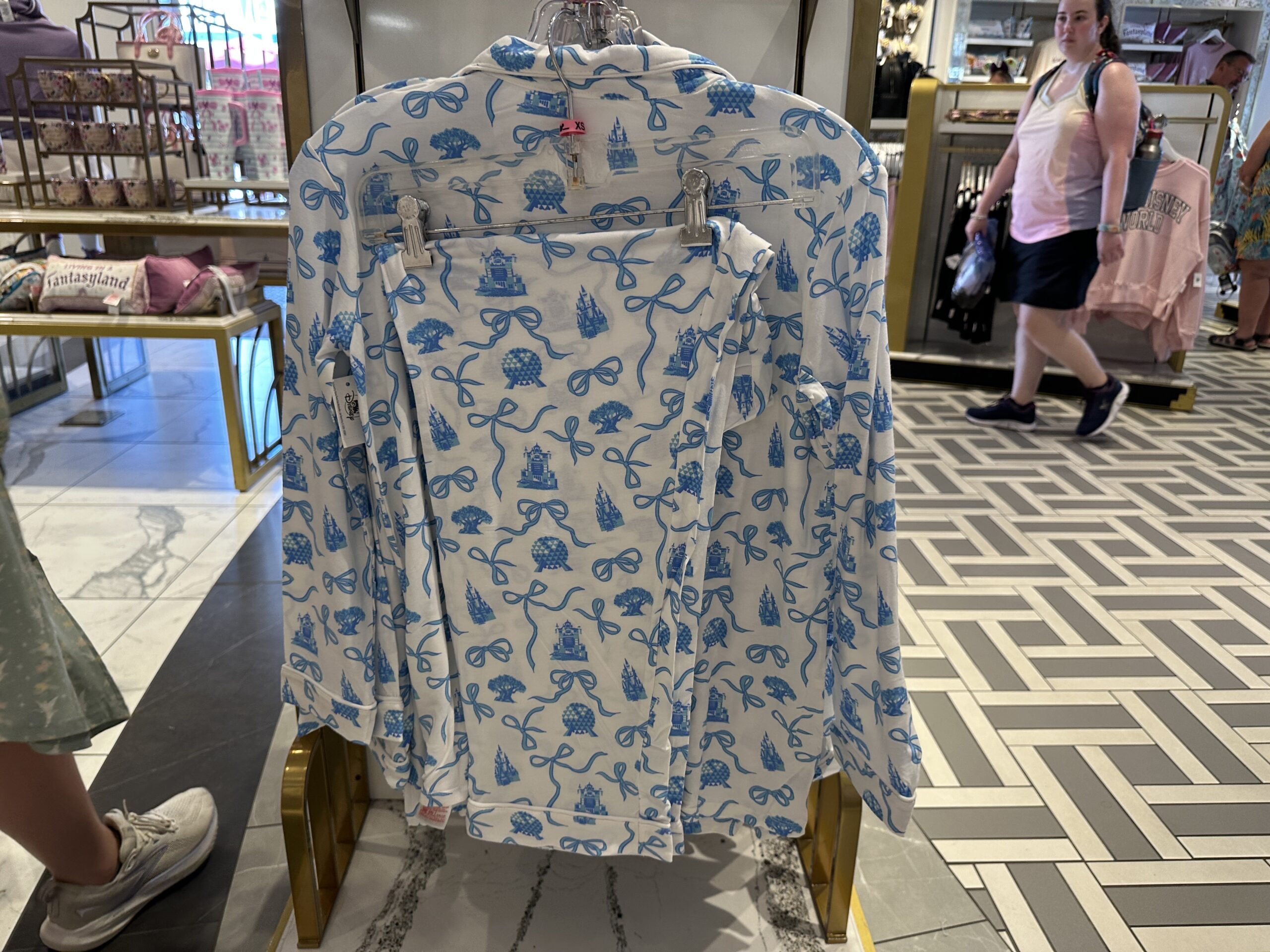 This white pajama set has the blue Fantasyland Castle and bows we've seen on other merchandise around the parks, including a recent new Starbucks tumbler. This set has a long-sleeved, button-up top and long-sleeved pants.