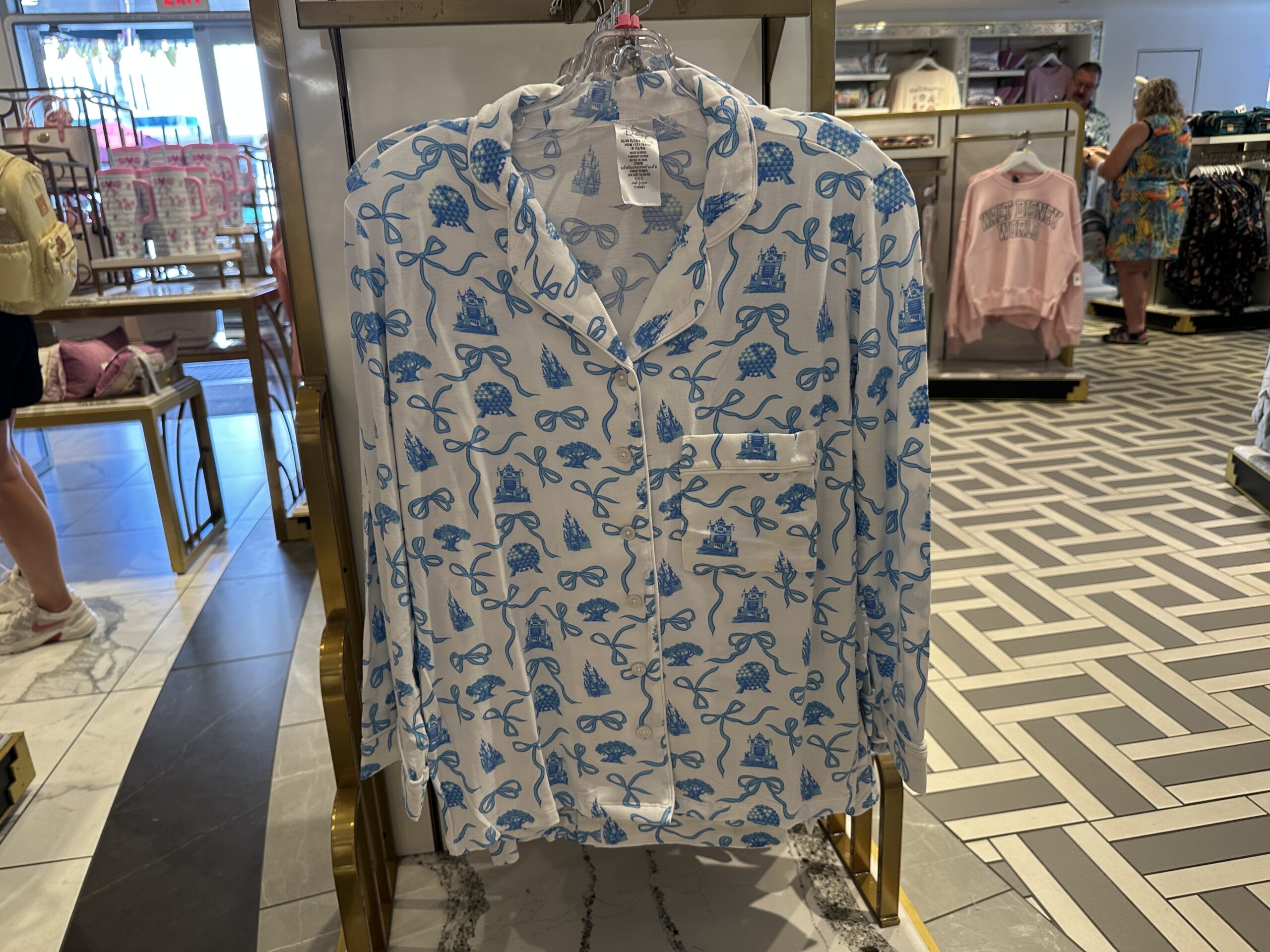 This white pajama set has the blue Fantasyland Castle and bows we've seen on other merchandise around the parks, including a recent new Starbucks tumbler. This set has a long-sleeved, button-up top and long-sleeved pants.