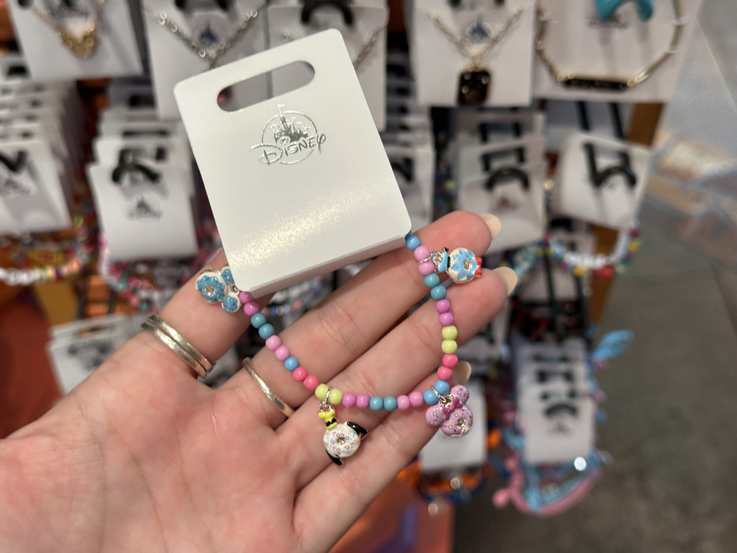 This bracelet, which resembles a candy bracelet, has the same charms as the necklace above. It is full of round beads with colors that match the charms.