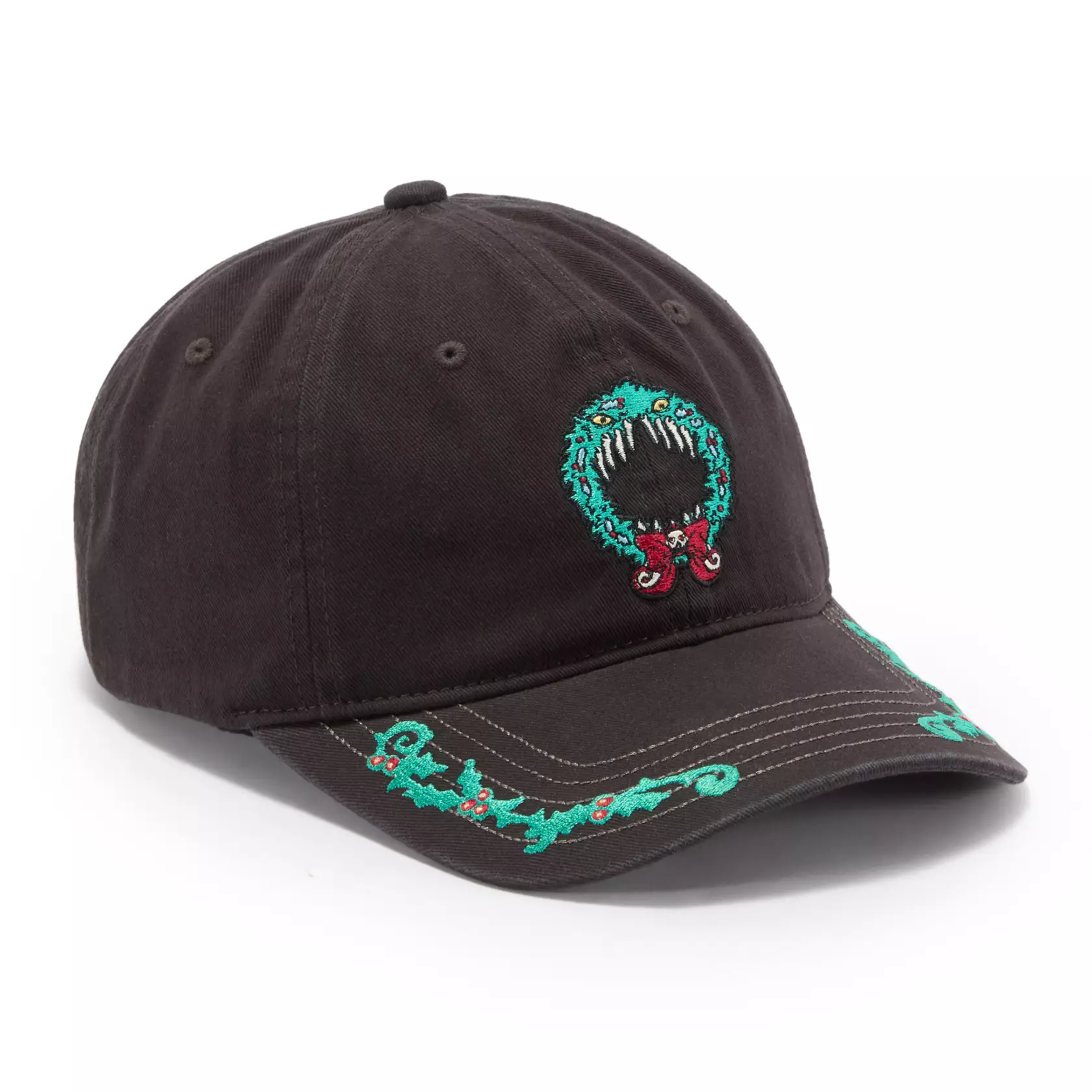 This ball cap is inspired by Haunted Mansion Holiday, Disneyland's seasonal overlay for The Haunted Mansion featuring The Nightmare Before Christmas characters. A holiday wreath with teeth and yellow eyes is embroidered on the front of the black ball cap. Garland trims the edges of the curved brim.