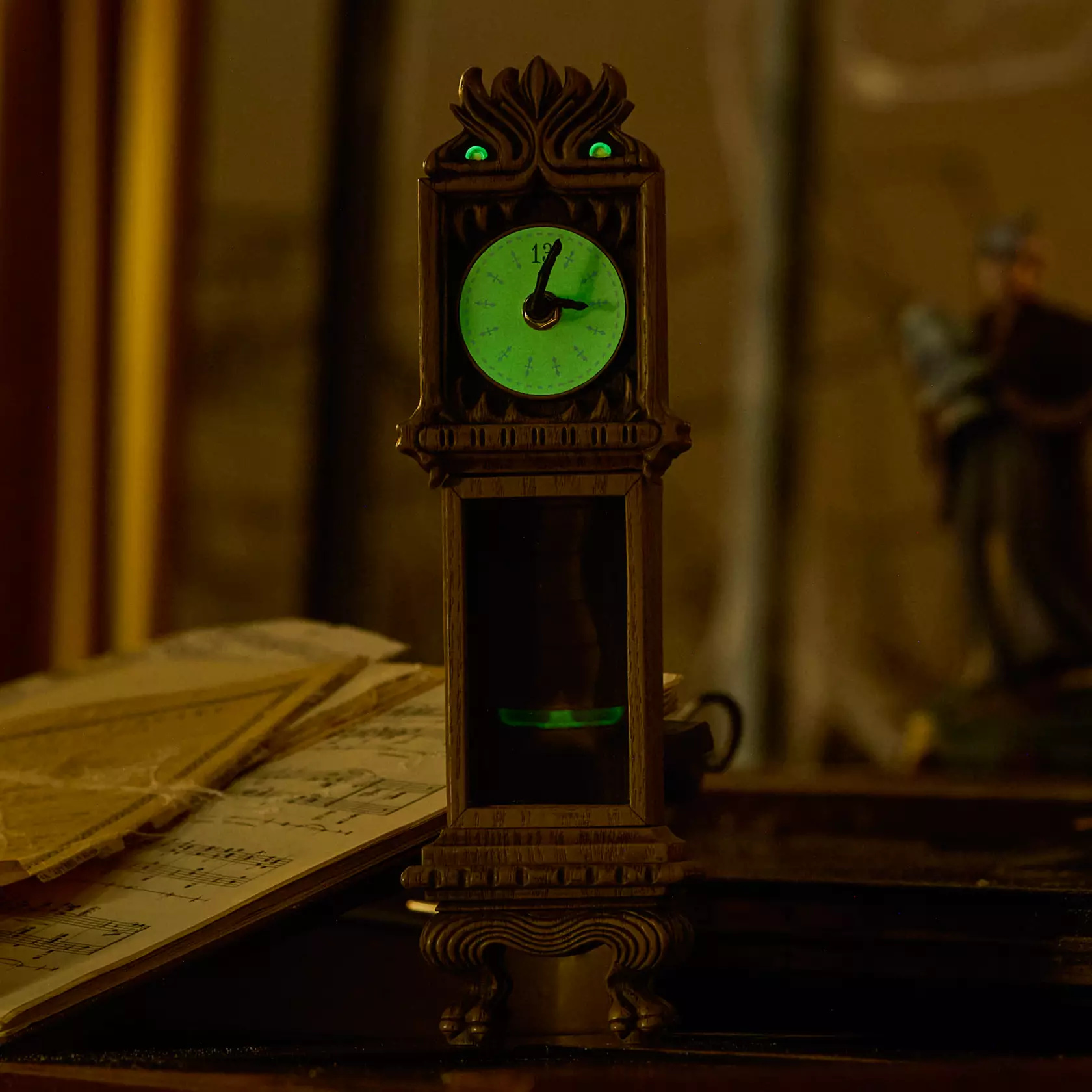 This 13.5" grandfather clock features monstrous details like green eyes and sharp teeth. The eyes and clock face glow in the dark. The clock hands actually move and the pendulum swings back and forth.
