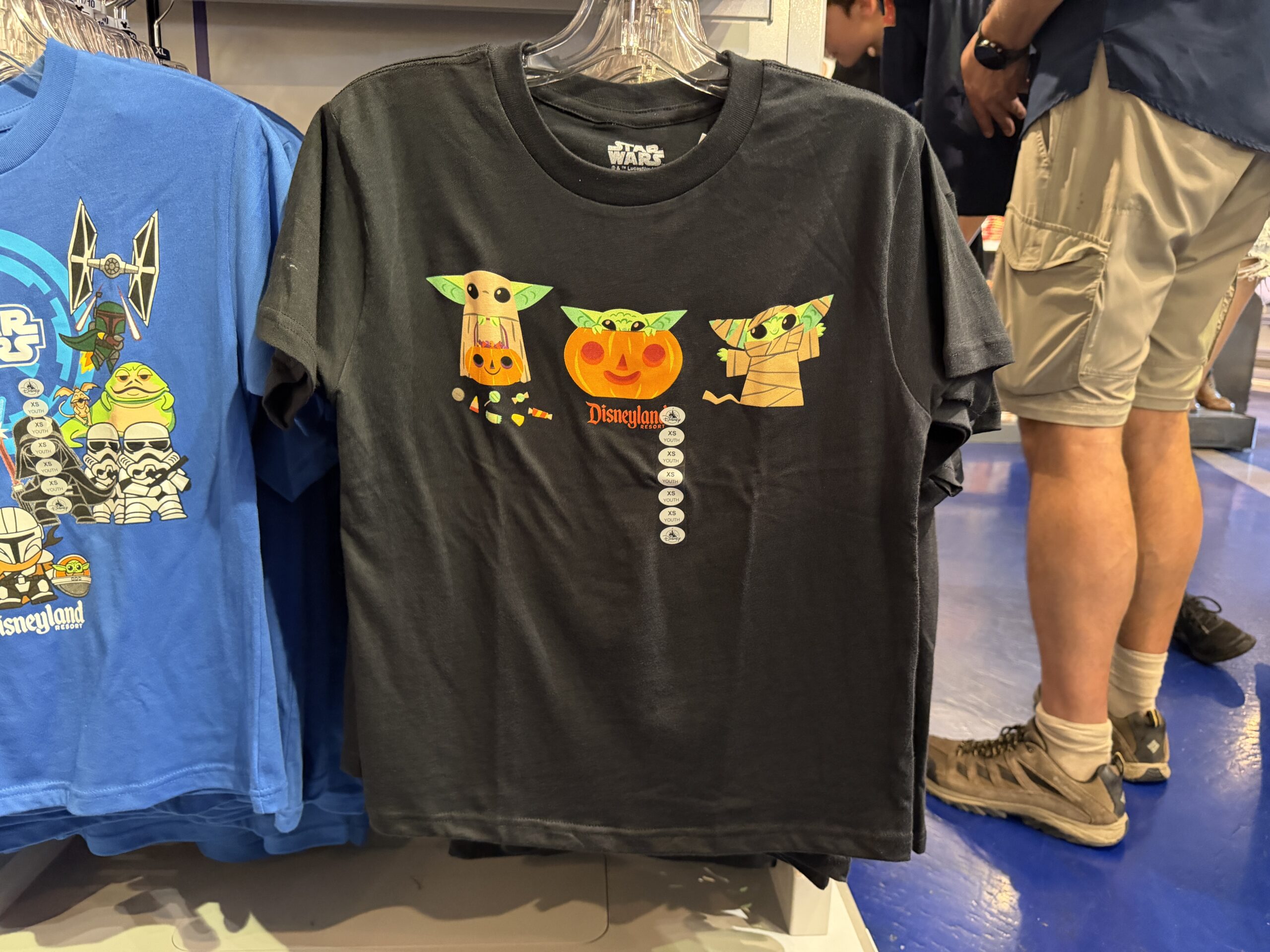 This black tee has three images of Grogu: trick-or-treating with candy, sitting inside a Jack-o'-lantern, and dressed as a mummy.