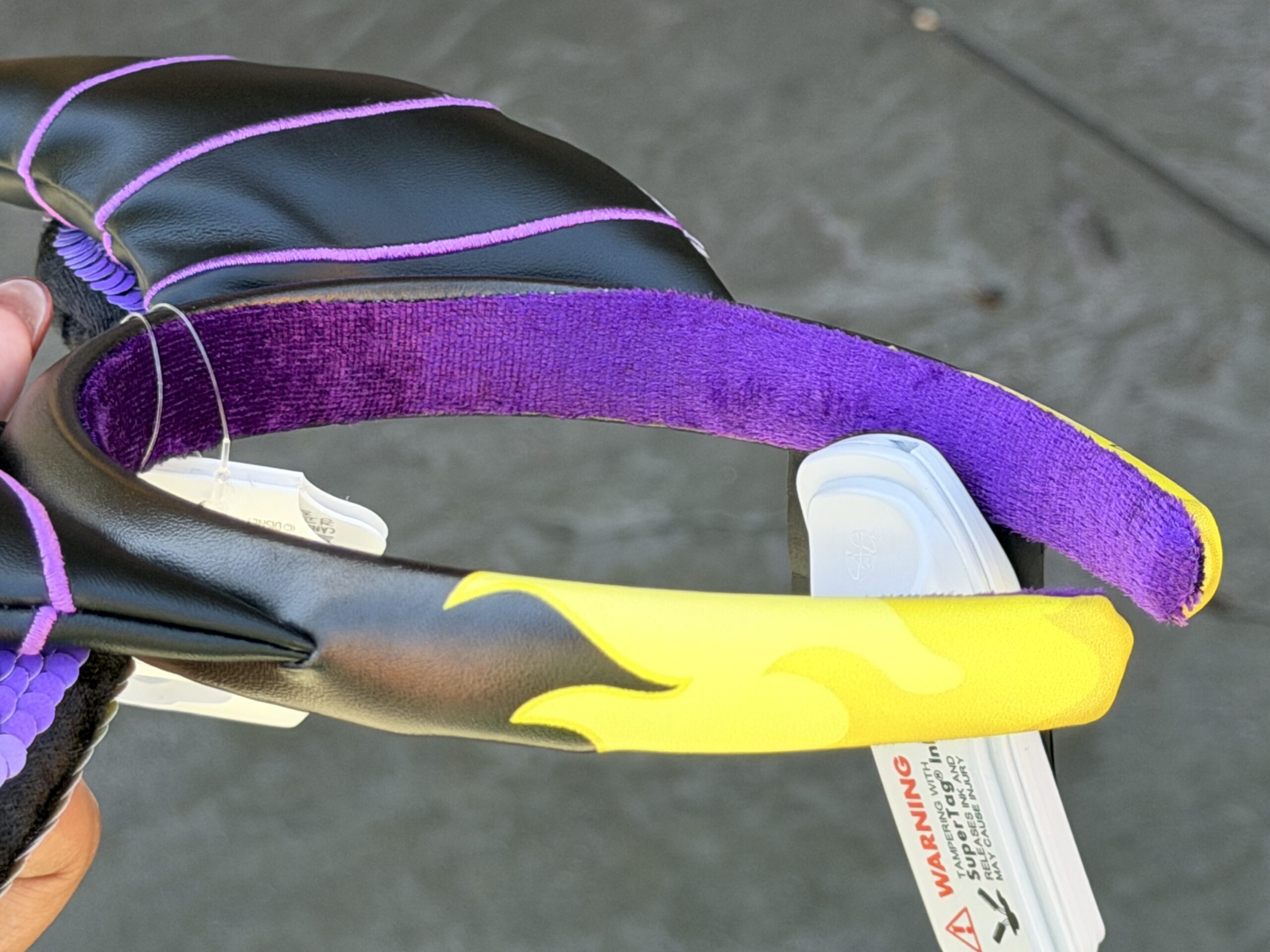 The faux leather continues down the outside of the band with yellow flame details. It’s lined with purple velour.