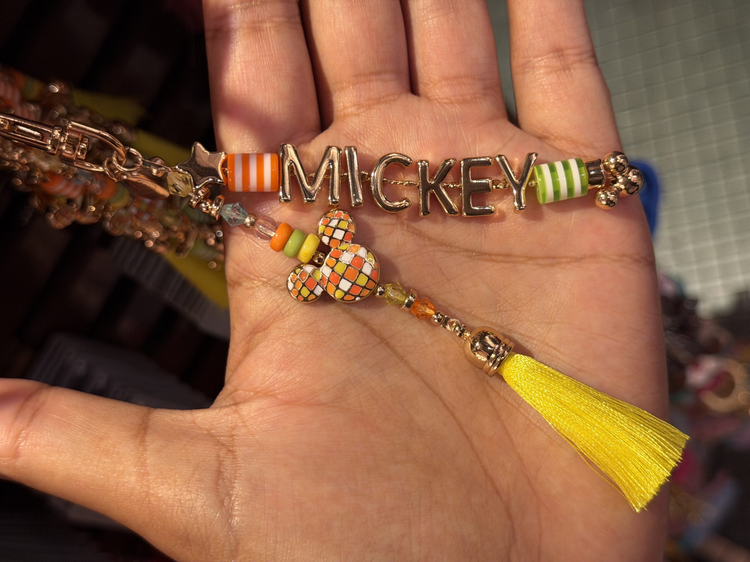 The matching Mickey bag charm has yellow, orange, and green beads, including the disco Mickey ball charm.