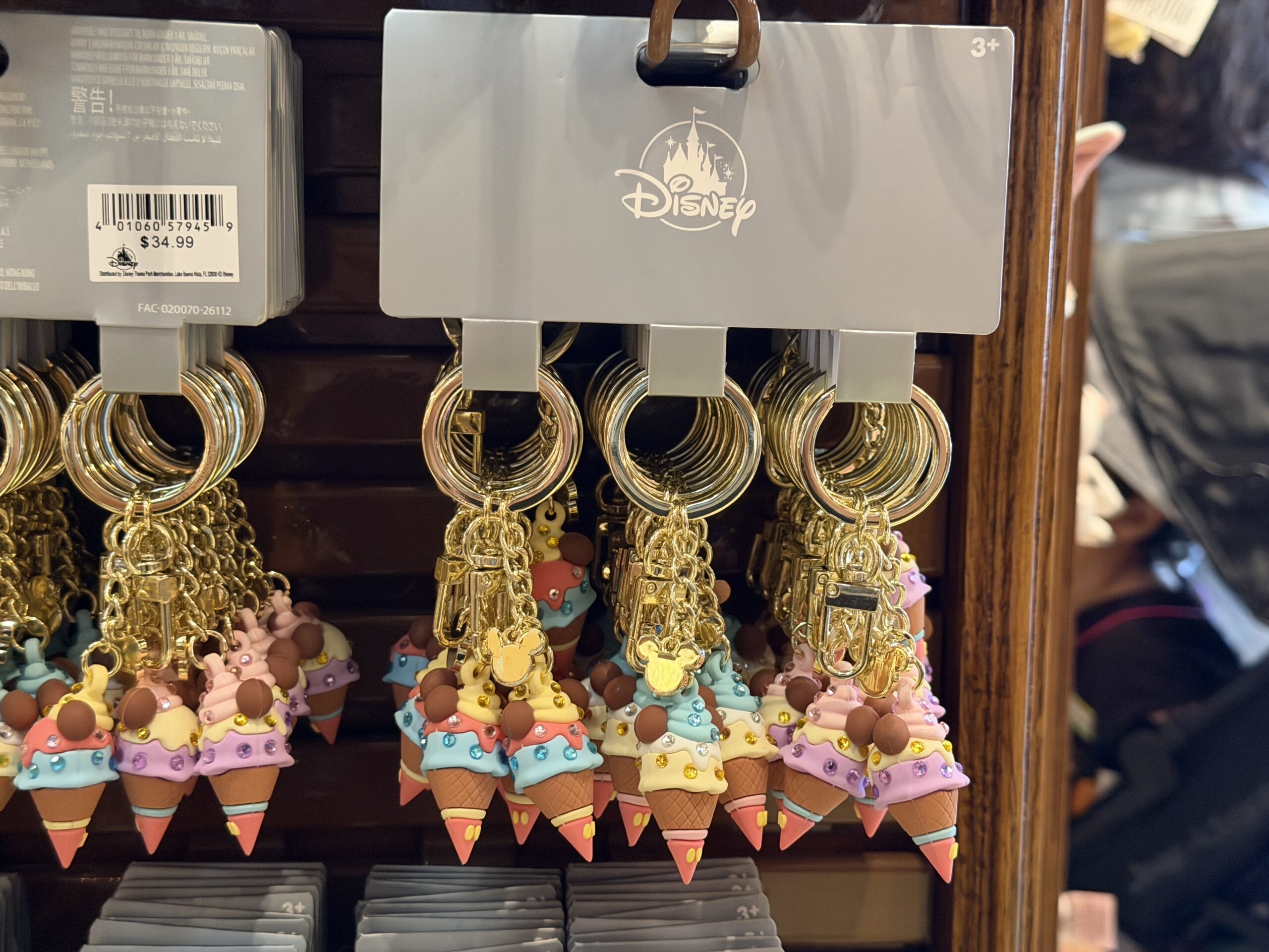 Another trio of keychains each feature a Mickey-shaped ice cream cone charm. These are multi-colored with gem details.