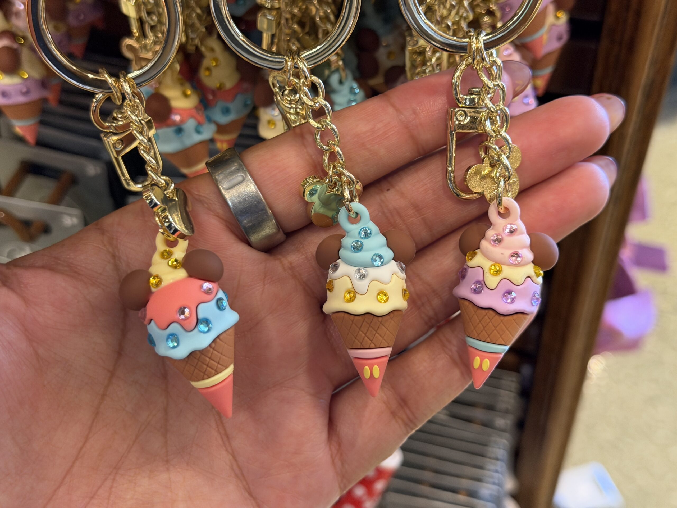 Another trio of keychains each feature a Mickey-shaped ice cream cone charm. These are multi-colored with gem details.