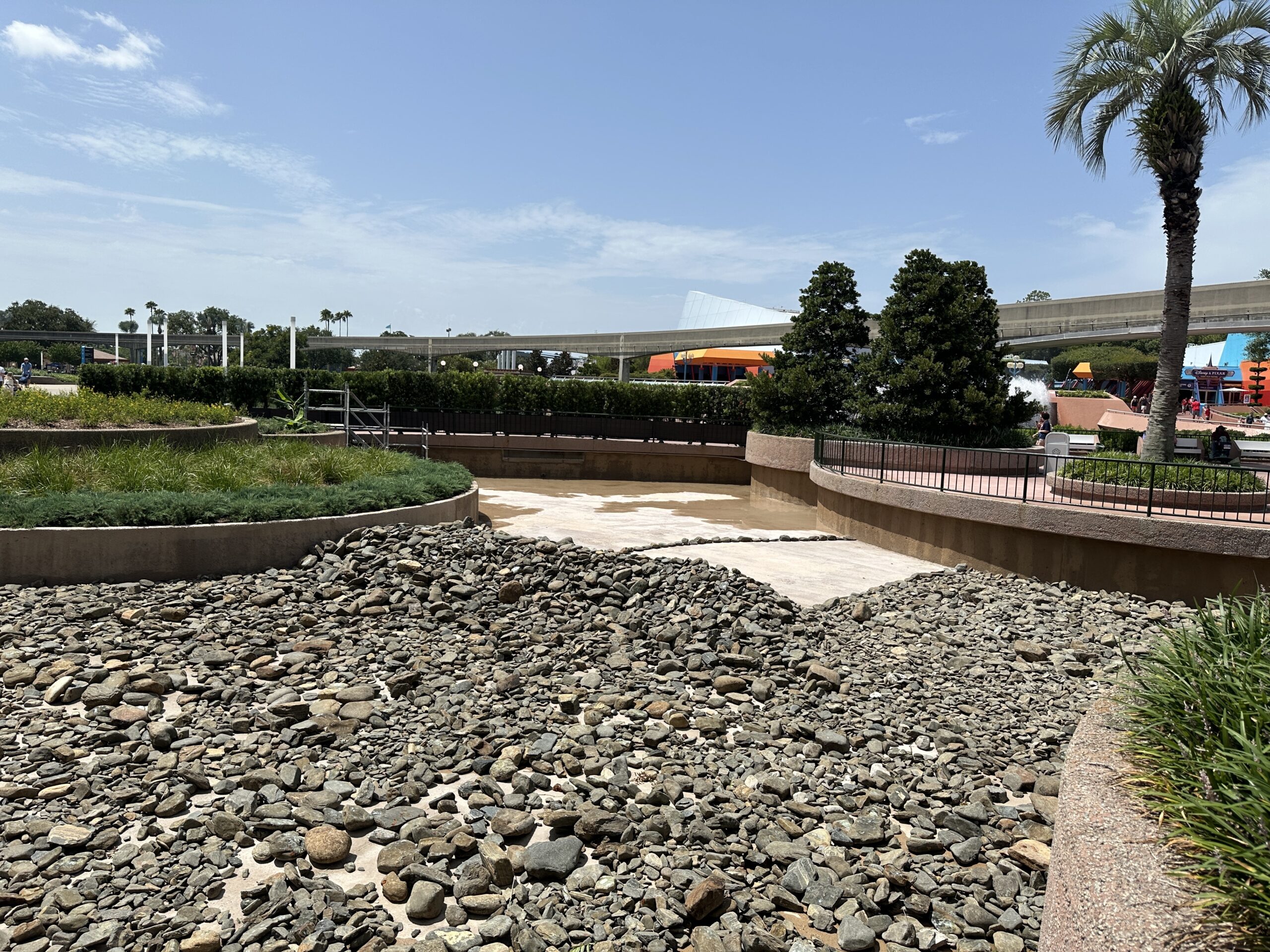 The rocks have been filled in where the bottom of the reflecting pool was recently repainted. There is a line of rocks along the bottom of the pool (as seen in the lefthand photo above) which we presume indicates an area that may need to be repainted. All coins that were mixed in with the rocks have also been removed.
