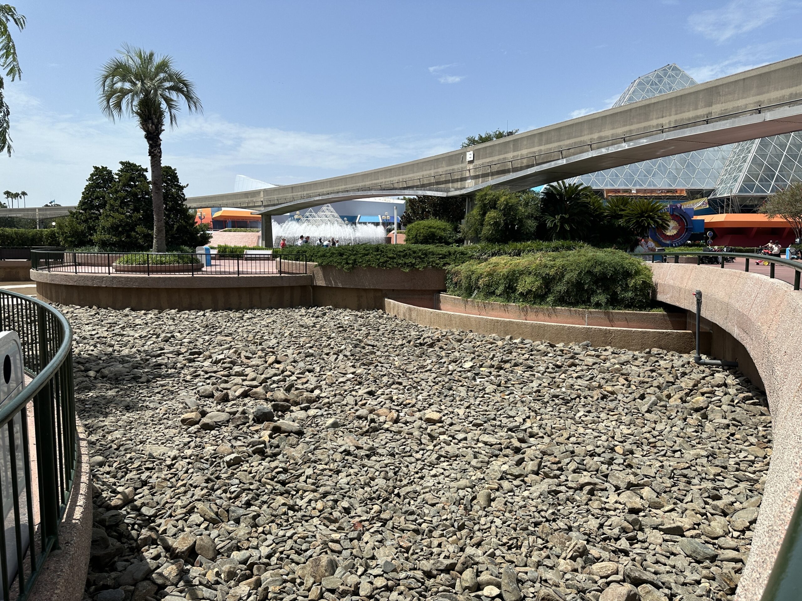 The reflecting pool draining/refurbishment began in mid-June when we saw the water taken out and river rocks piled together throughout the area. The affected area is the body of water between the Imagination Pavilion and the Land Pavilion closest to CommuniCore Plaza.