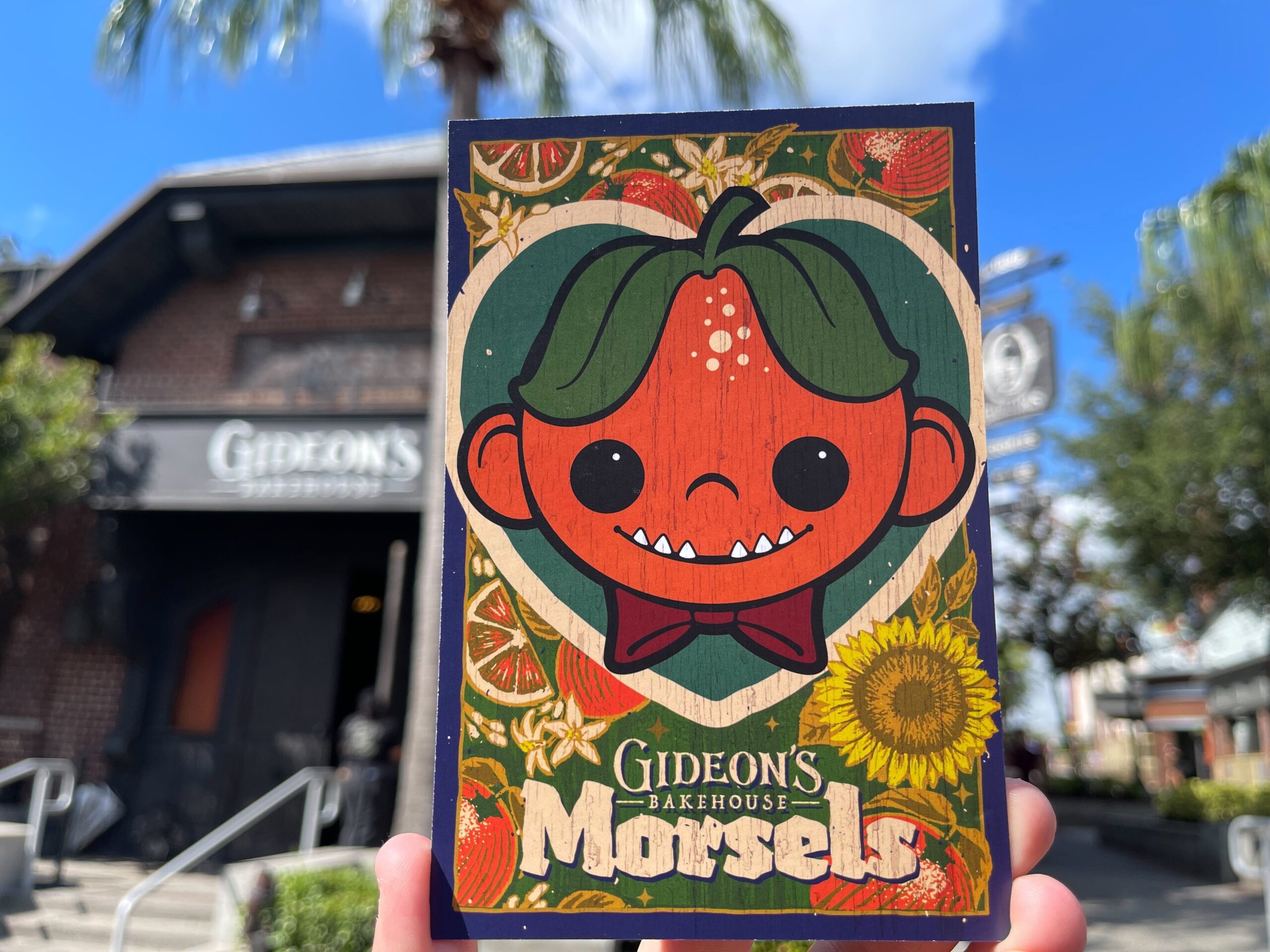 This month's meny features Stuart Valencia, one of Gideon's oldest and most iconic characters. He is inside a heart on this new menu card decorated with summery imagery like sunflowers and oranges (that match Stuart's head).
