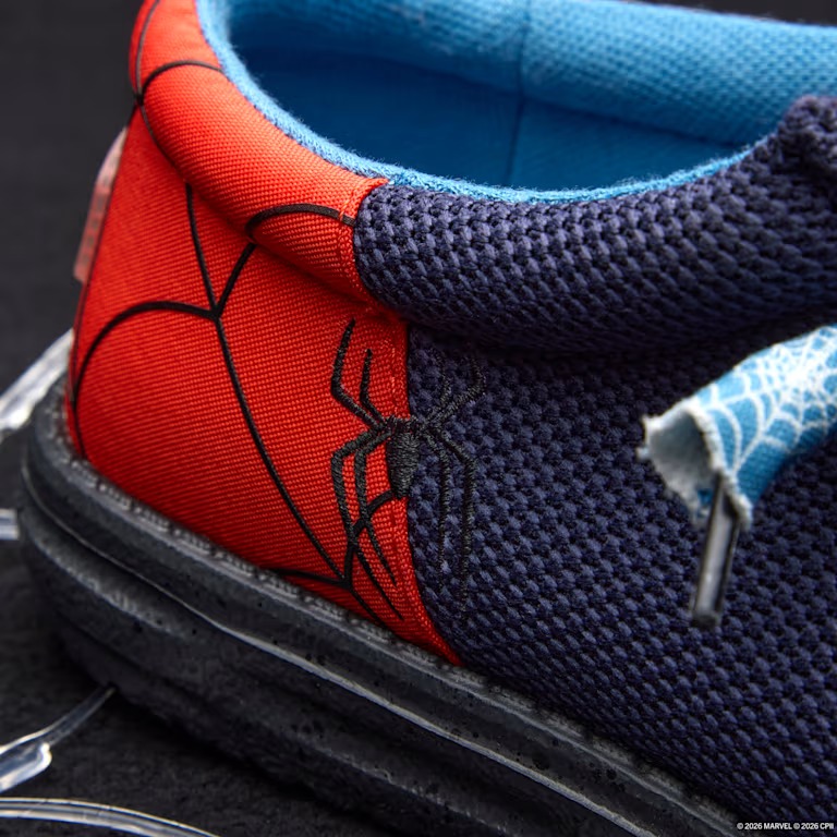 A spider logo is embroidered in black on the sides. The ends of the black elastic laces feature blue web-patterned tassels. The lining is light blue with Spider-Man printed on the right shoe's interior.