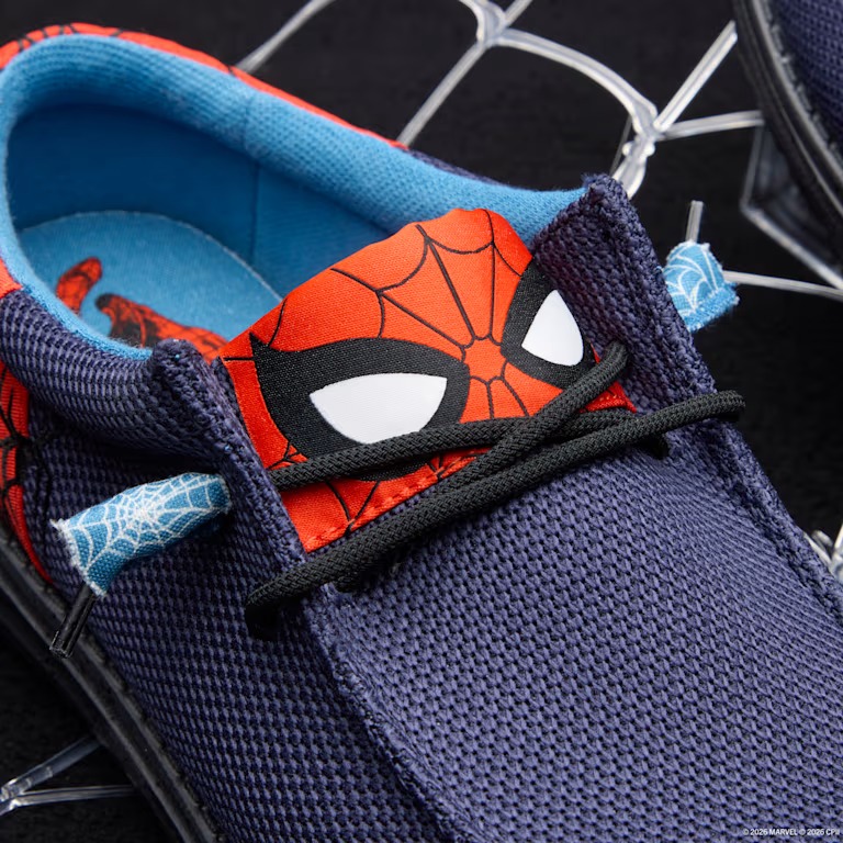 A spider logo is embroidered in black on the sides. The ends of the black elastic laces feature blue web-patterned tassels. The lining is light blue with Spider-Man printed on the right shoe's interior.