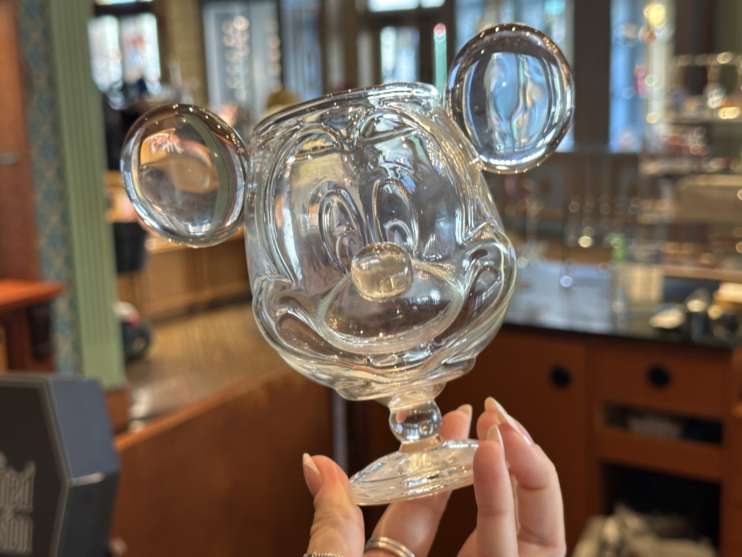 The fully shaped dish has an ear on each side, as well as Mickey's snout extending from the front. He appears to be smiling when looking at the dish from the front. It has a bulbous stem and rounded foot.
