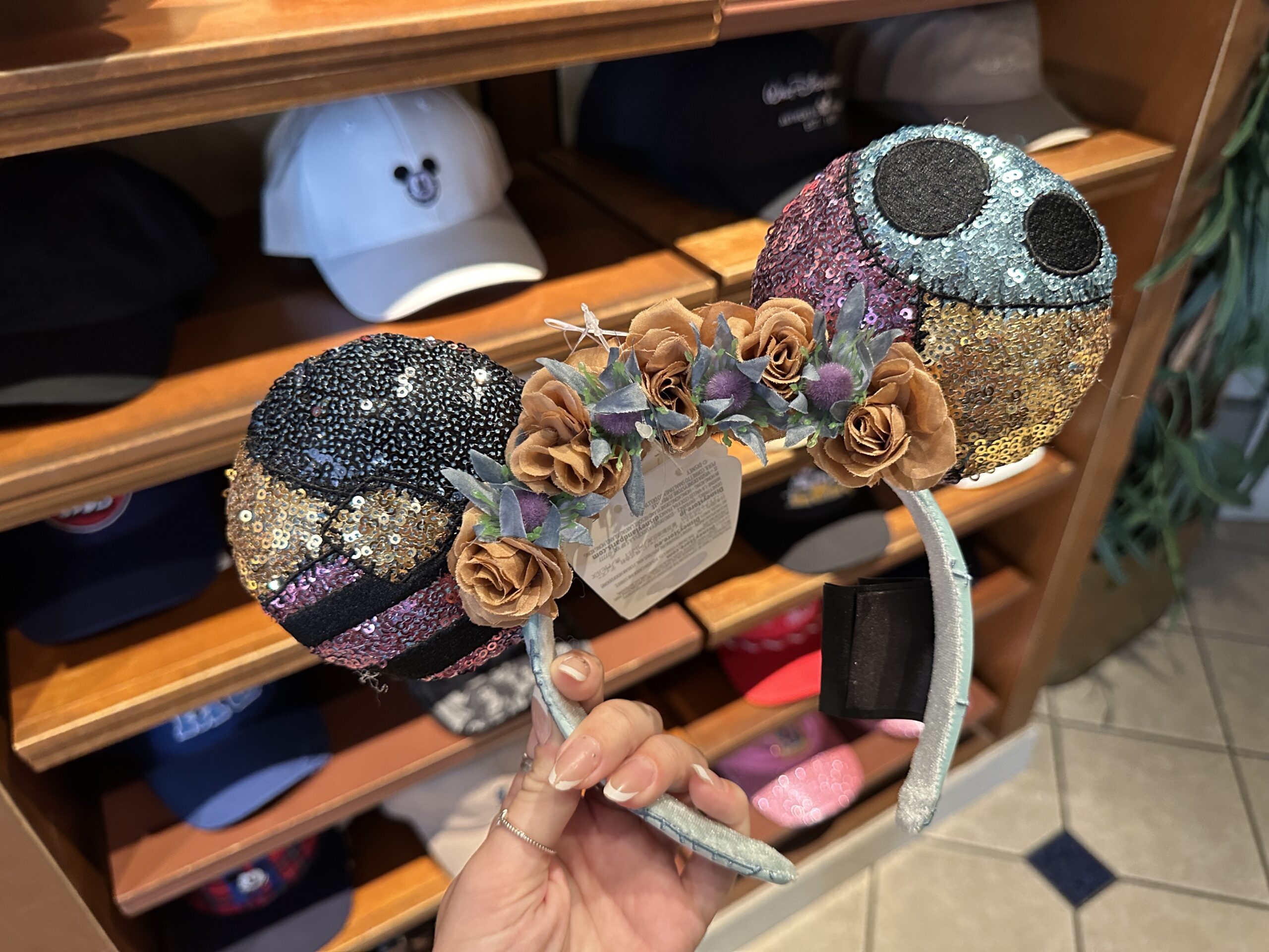 The ear headband, themed after Sally, represents her dress in two different decorated ears. Each is covered in multicolored sequins outlining some of the patterns found in her ramshackle dress.