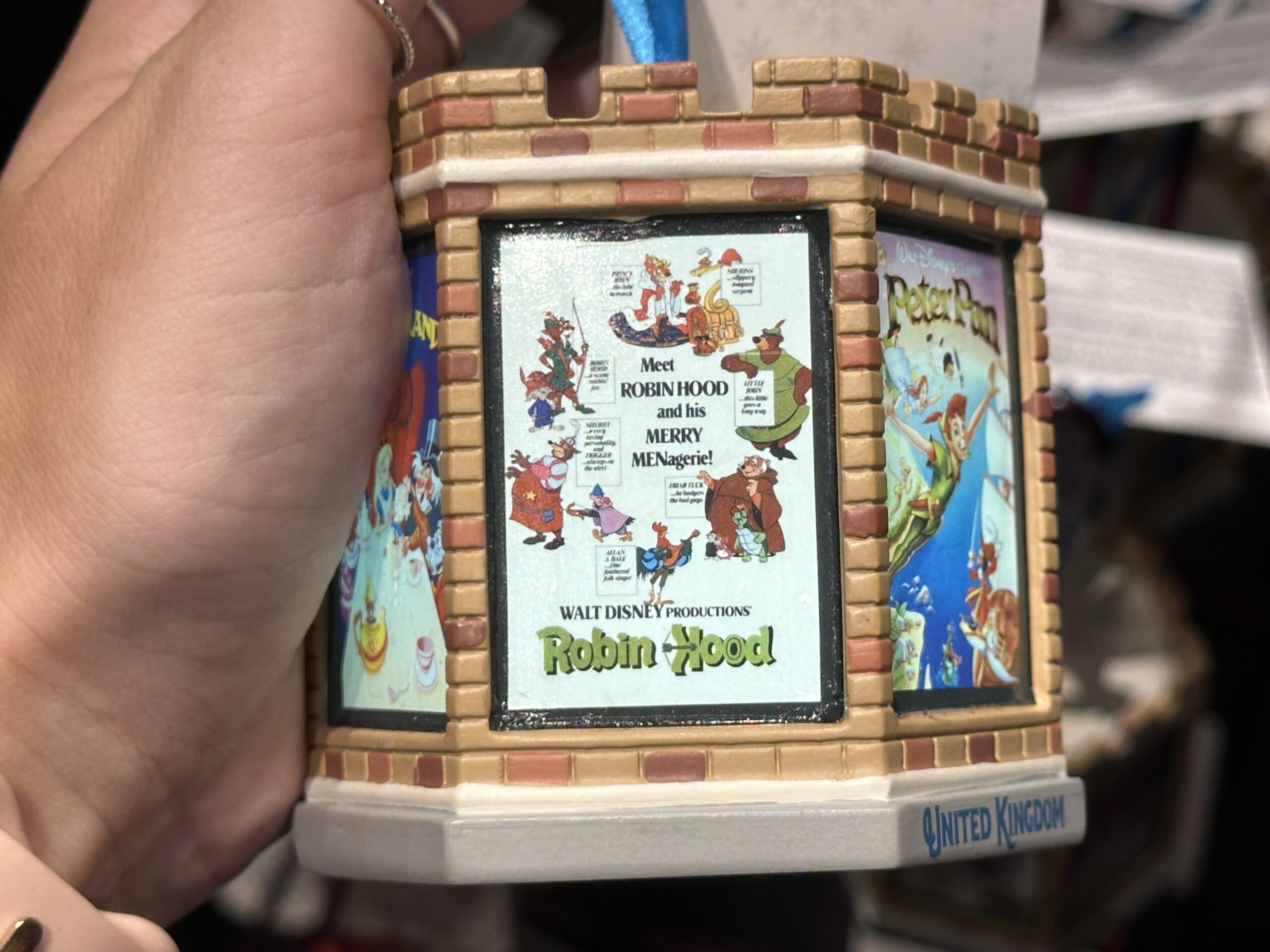 This six-sided, light-up ornament celebrates classic Disney films that took place in England. Each side has a different vintage poster from the film. These include Peter Pan, The Sword in the Stone, One Hundred and One Dalmatians, Icabod and Mister Toad, Alice in Wonderland, and Robin Hood.