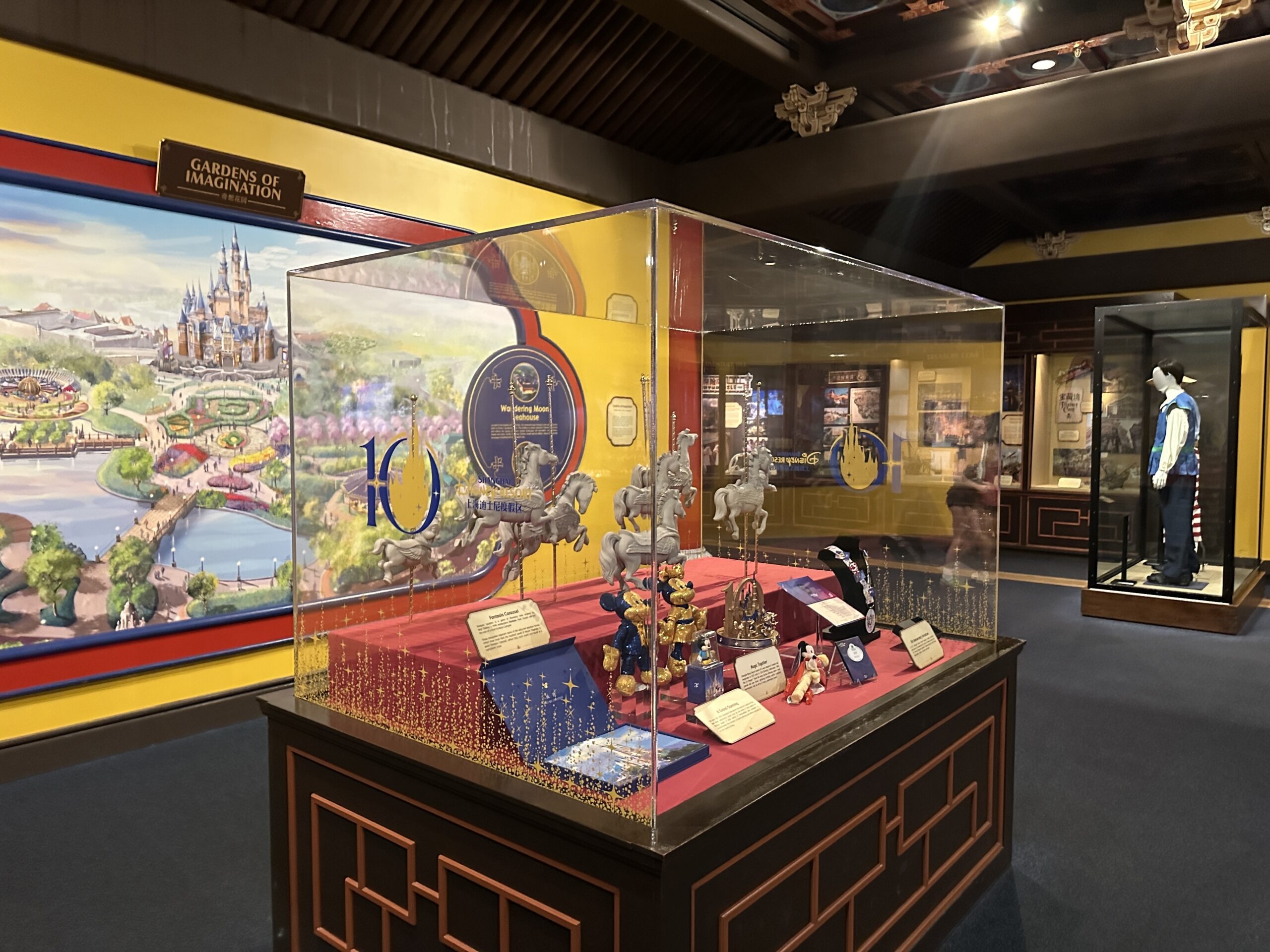The museum display has Shanghai Disney Resort 10th anniversary iconography on the outside and several items from the resort's history on display.