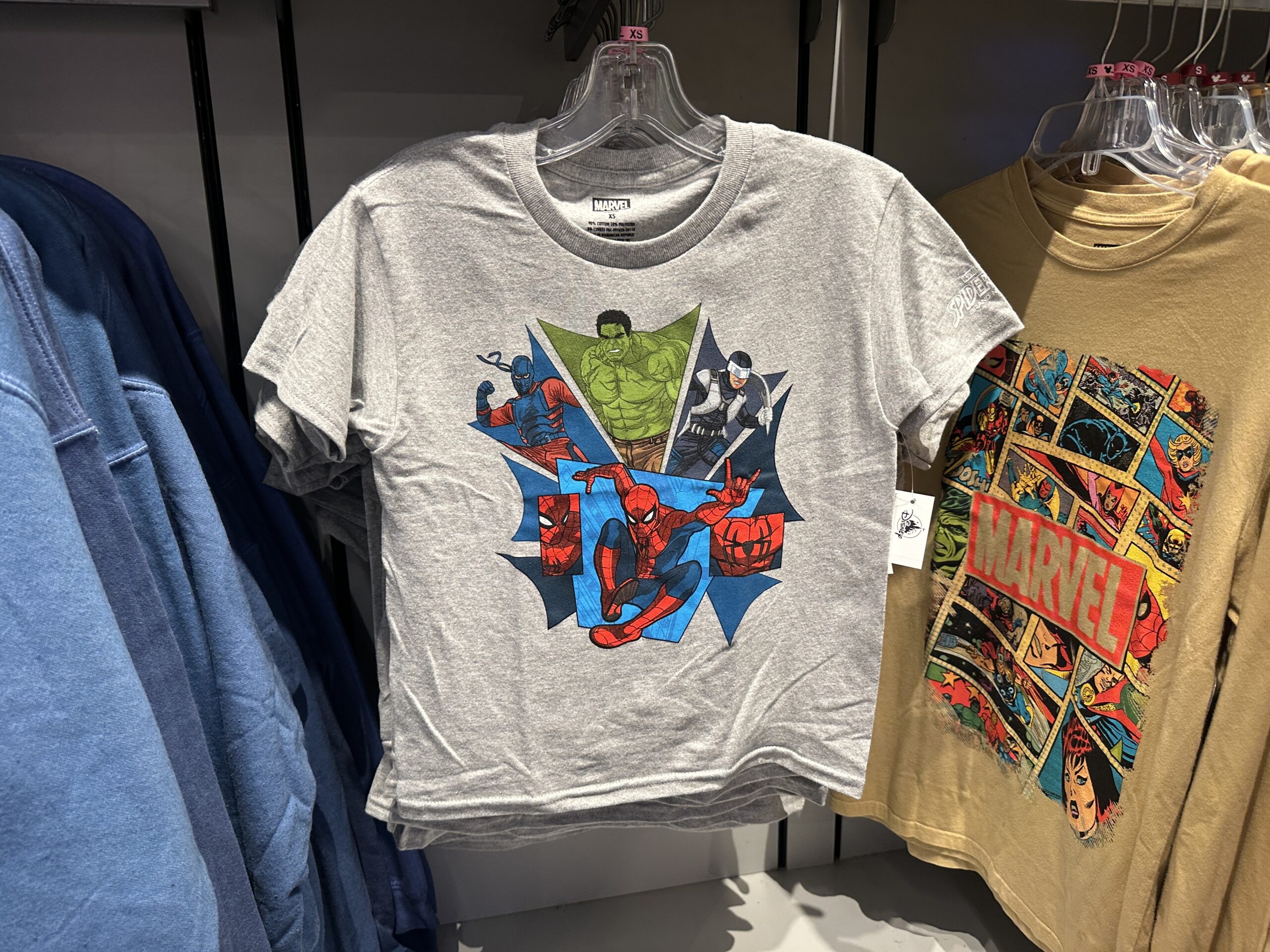 In youth sizing, this gray T-shirt has a spider web design with various Spider-Man characters in it, including Hulk and Spidey himself.