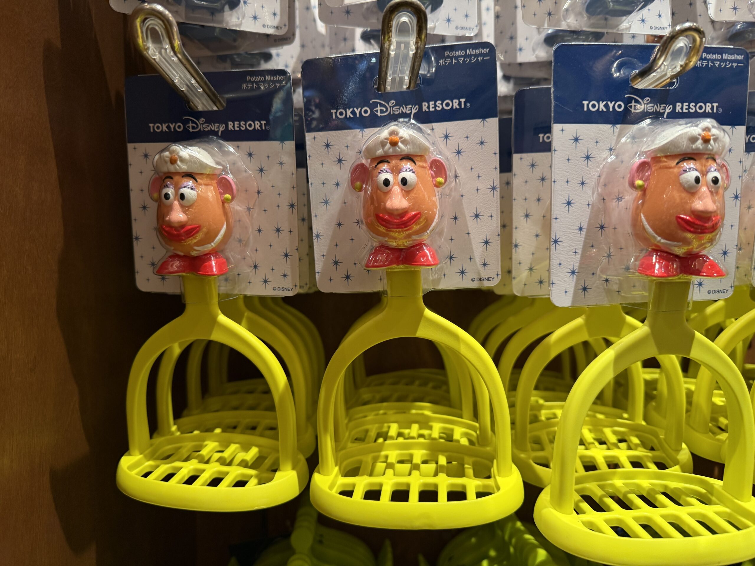Similarly, this lime green potato masher is connected to a handle that is shaped like Mrs. Potato Head.