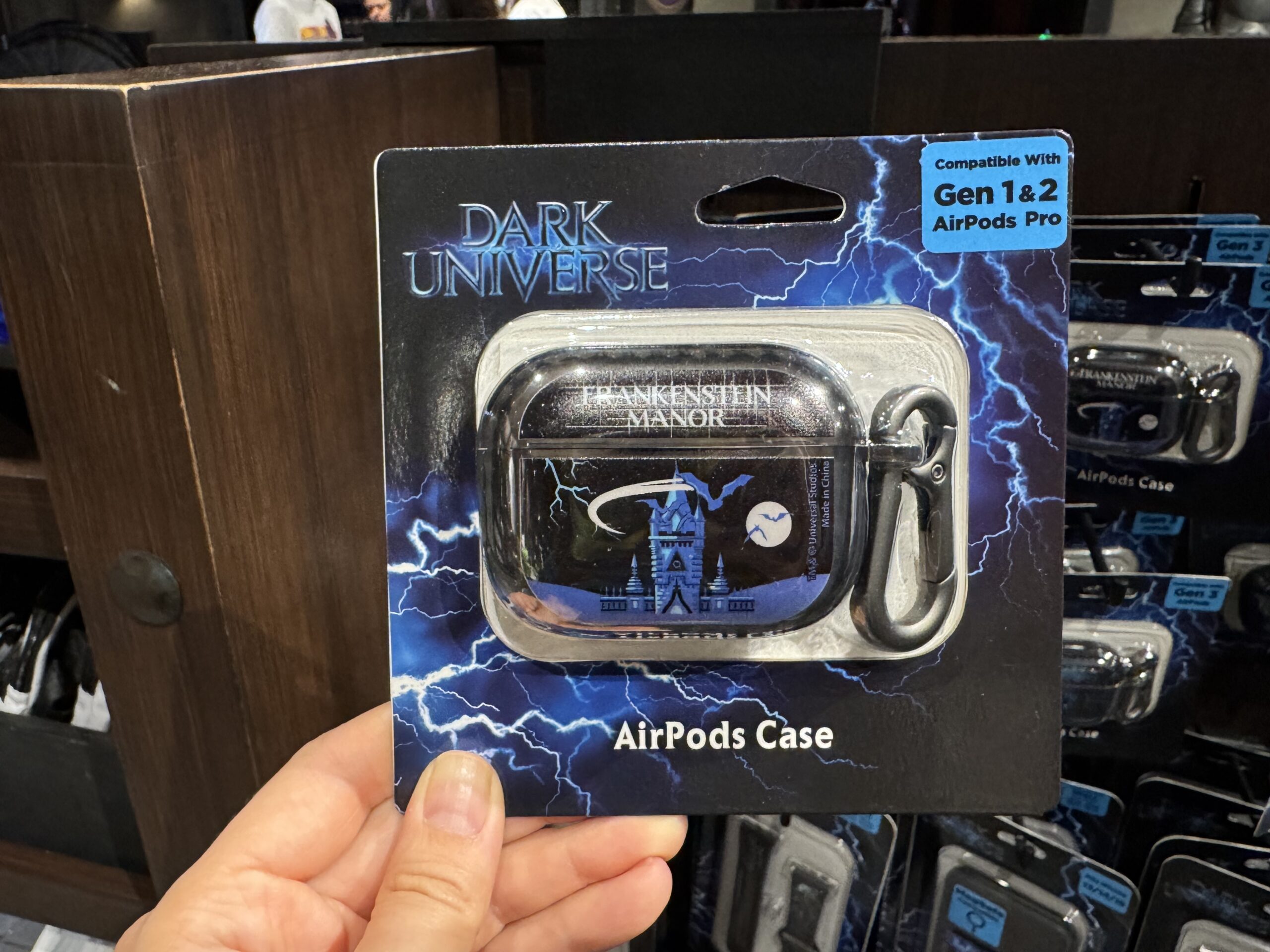 There are multiple versions of the AirPods case for Gen 1 and 2 AirPods Pro and Gen 4 AirPods. All three styles feature the towers of Frankenstein Manor in blue with bats flying across the sky and moon. "Frankenstein Manor" is in white on the lid.