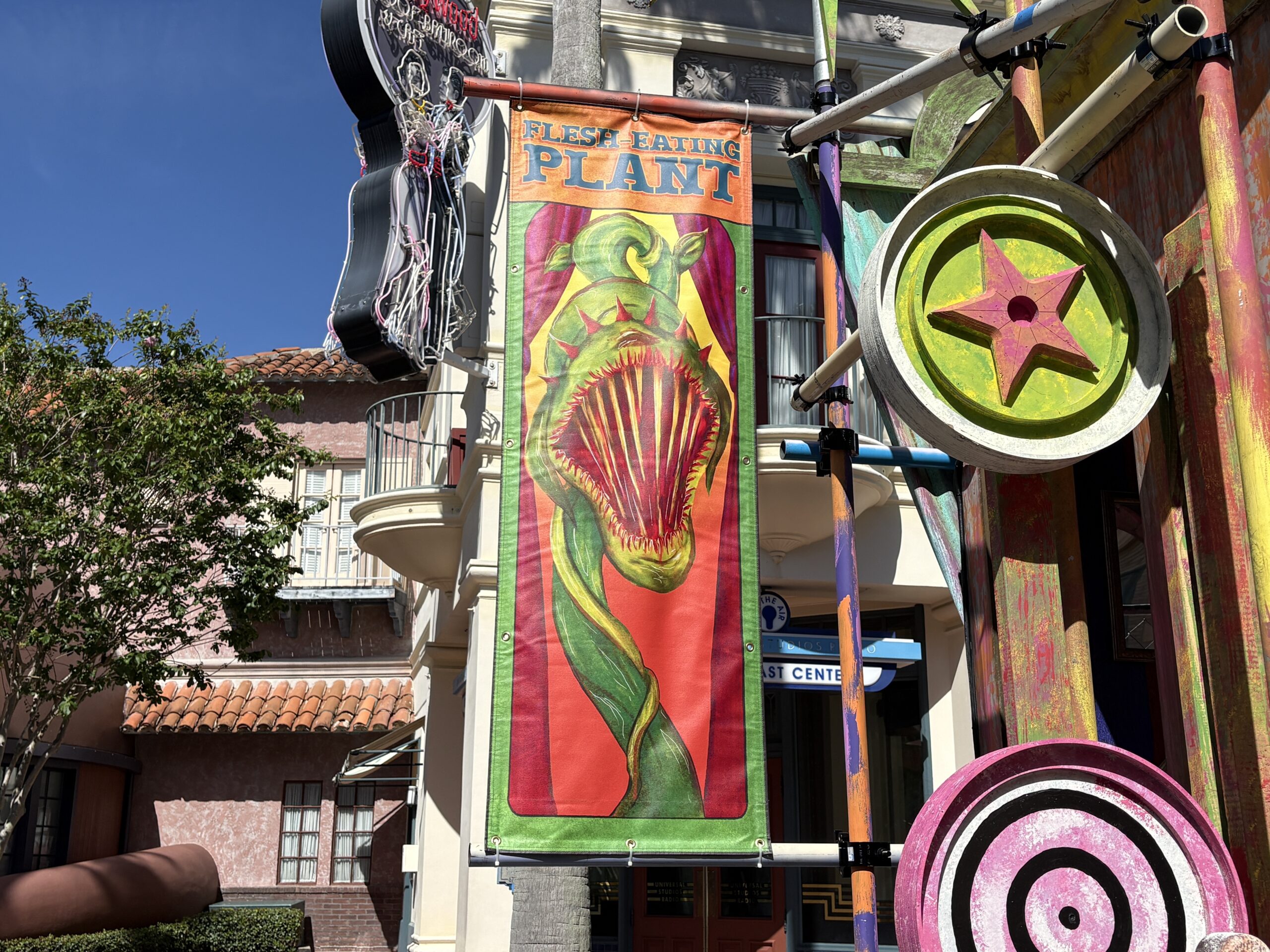 Made up of weathered but colorful walls, banners, and broken attractions, each set has a different theme. This one, as seen on the sign above the stage, is the "Unnatural," featuring strange creatures. Banners advertise a gigantic mantis, hissing roaches, deadly wasps, and a flesh eating plant.
