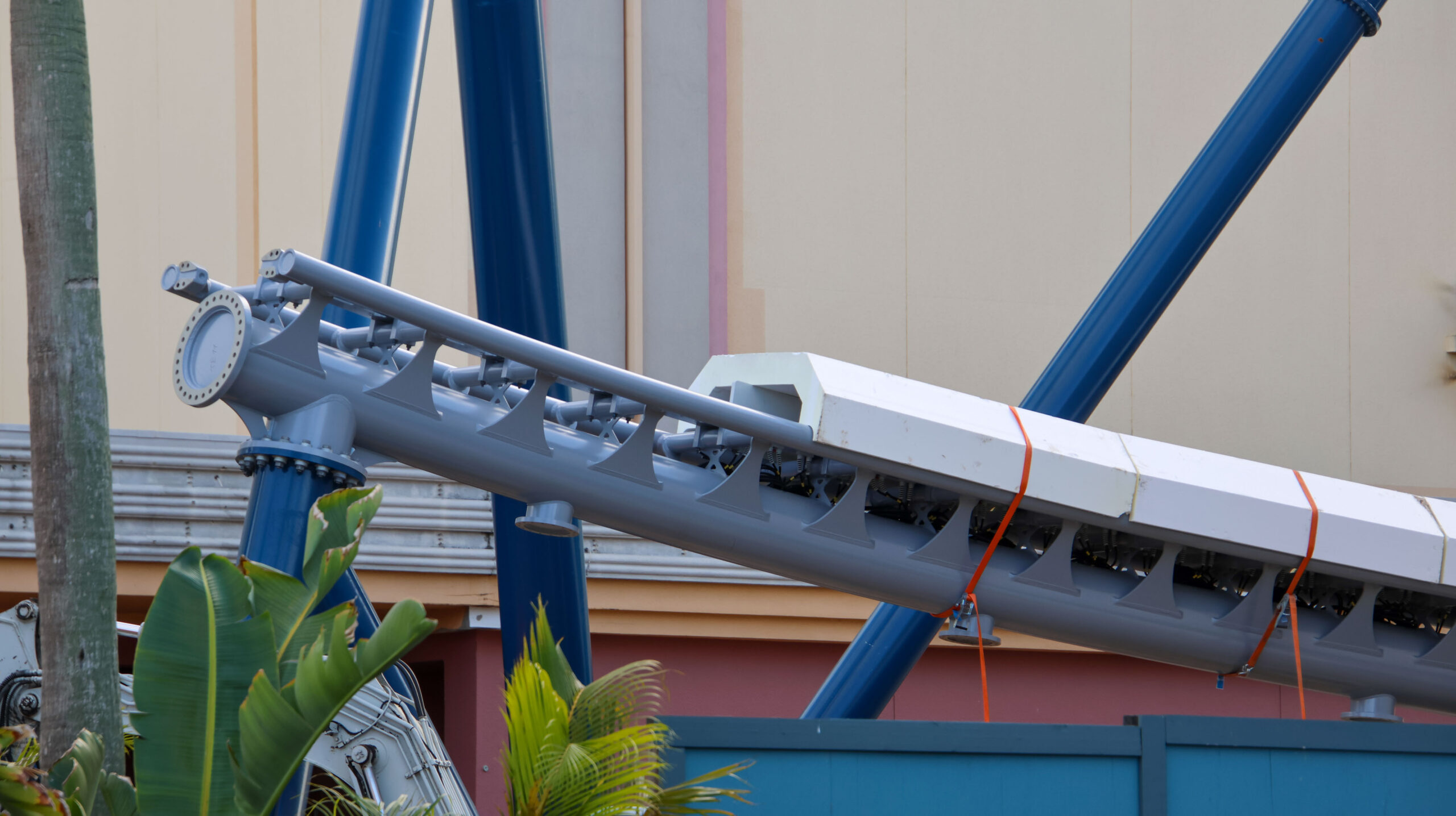 Protective foam has been strapped over a stretch of propulsion fins, indicating track will soon be installed above. This track takes guests out of the station while the overhead track will take them back.