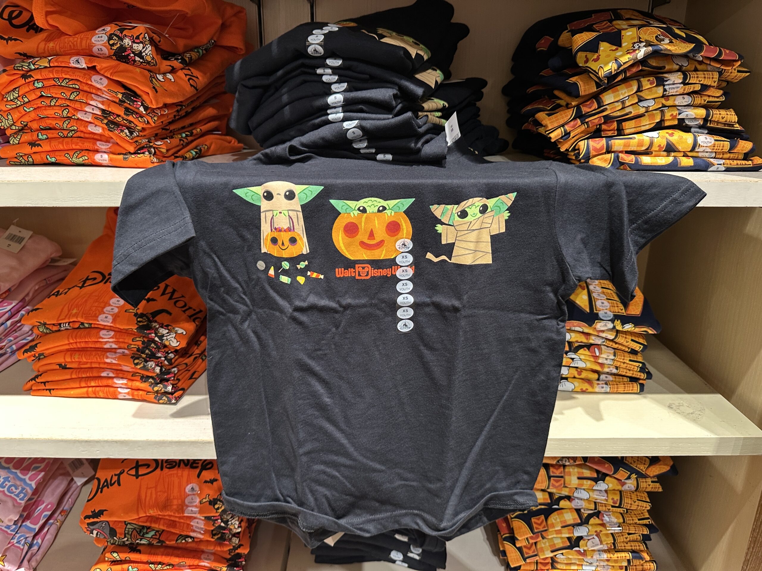 This black tee has three images of Grogu: trick-or-treating with candy, sitting inside a Jack-o’-lantern, and dressed as a mummy.