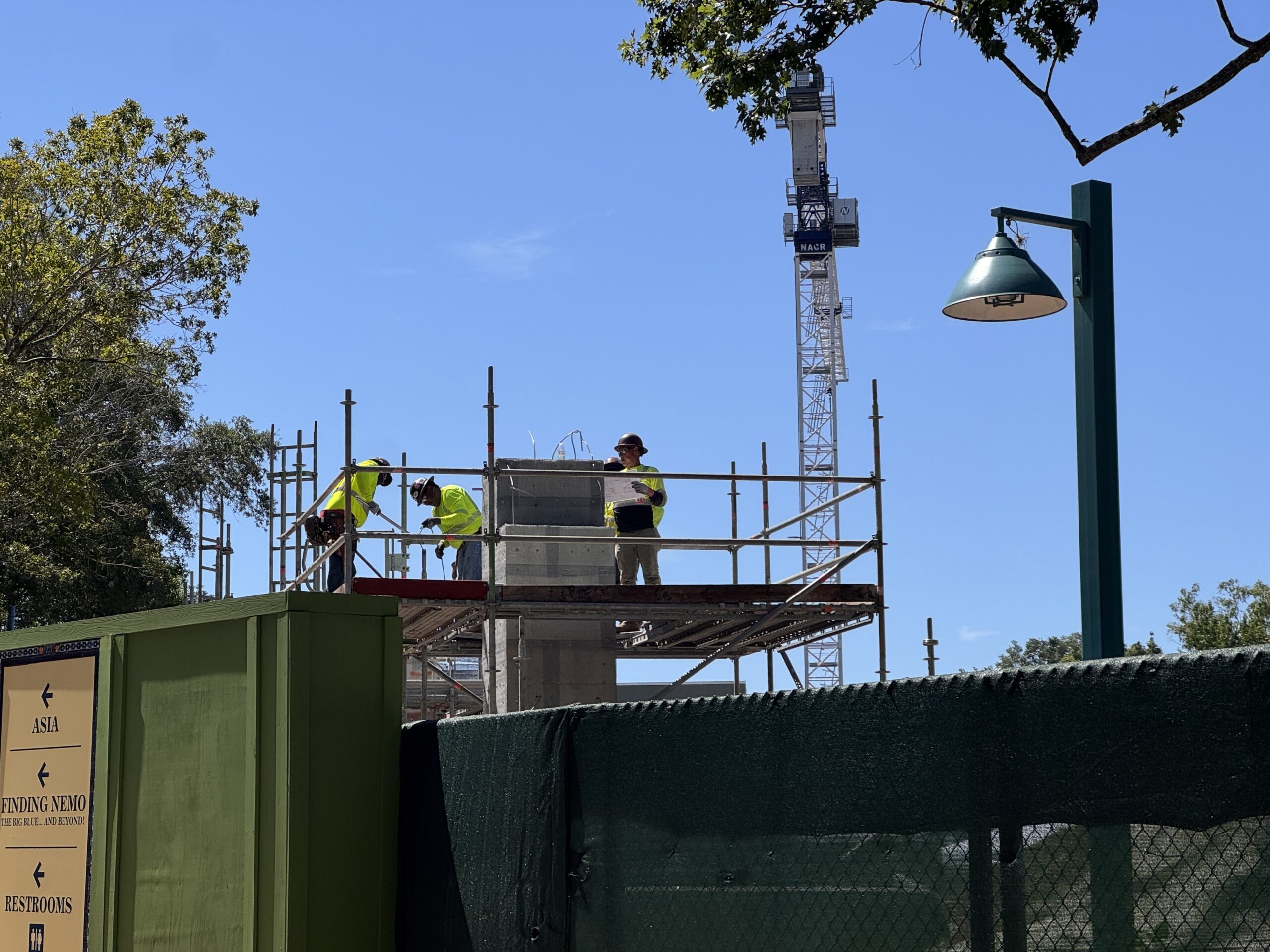 A few hours after our initial check on Thursday, we saw crew members had added rebar to the top of one of the entrance columns. The rebar is twisted to create the future shape of the additional concrete.