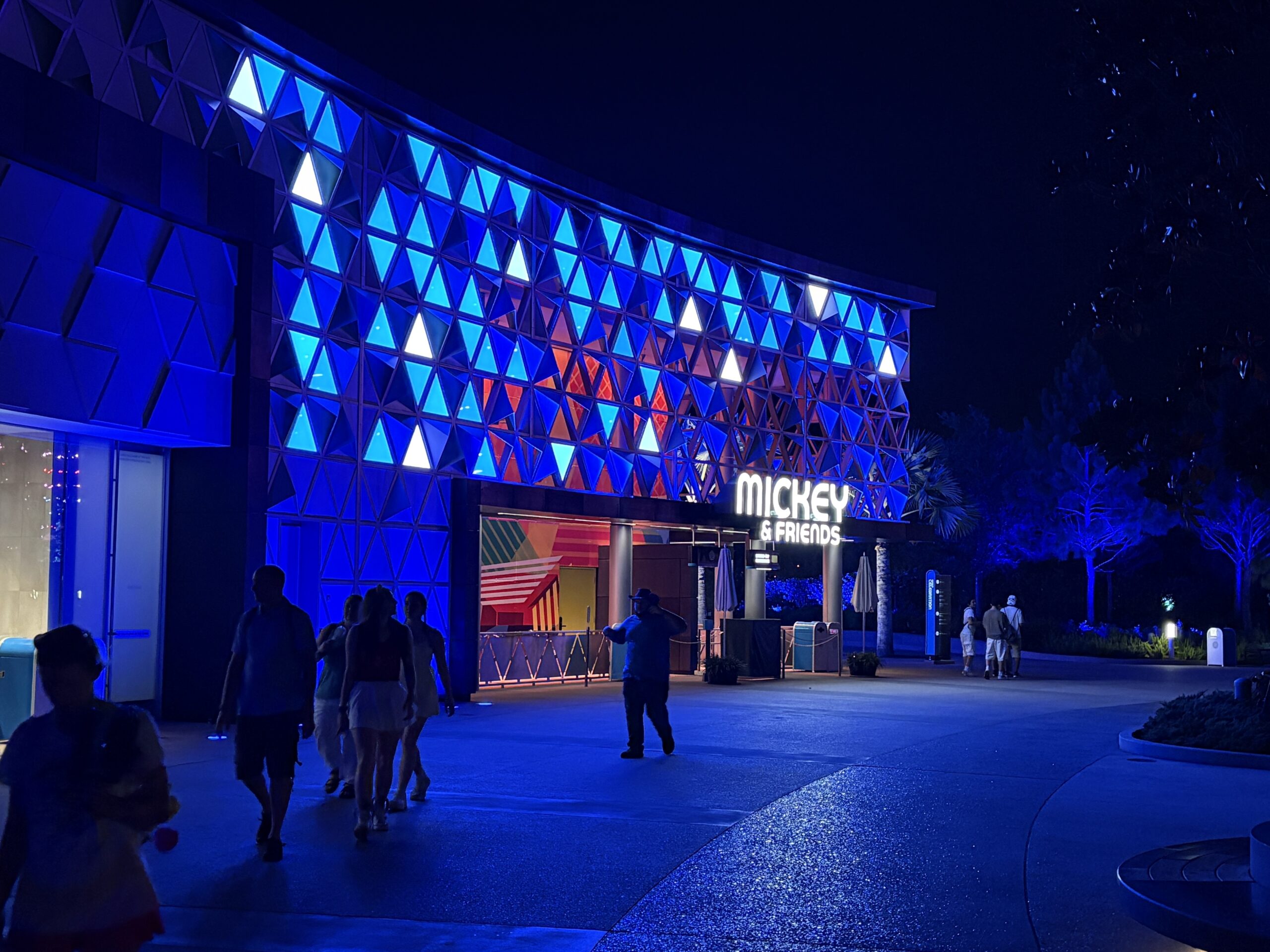 EPCOT has some patriotic lighting in place for America's 250th birthday this year. Spaceship Earth is decorated like an American flag, and other facades have red, white, and blue lighting.