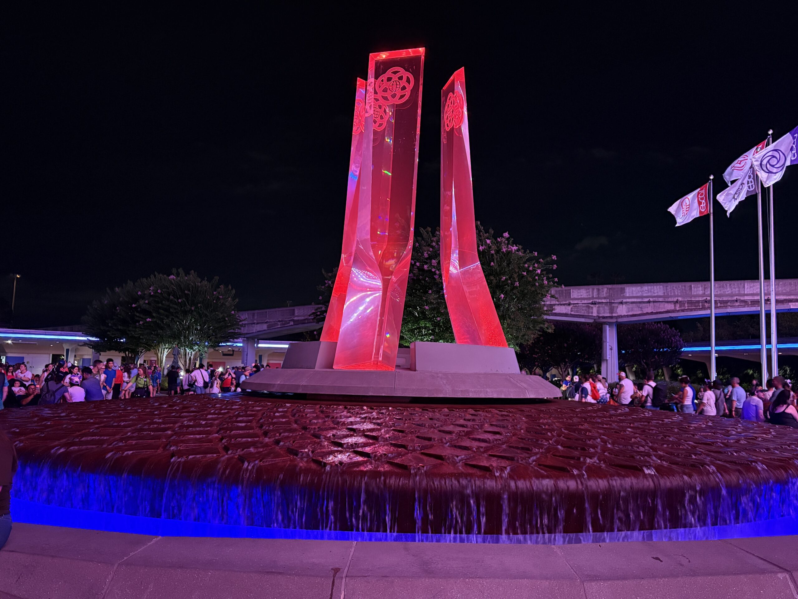 EPCOT has some patriotic lighting in place for America's 250th birthday this year. Spaceship Earth is decorated like an American flag, and other facades have red, white, and blue lighting.