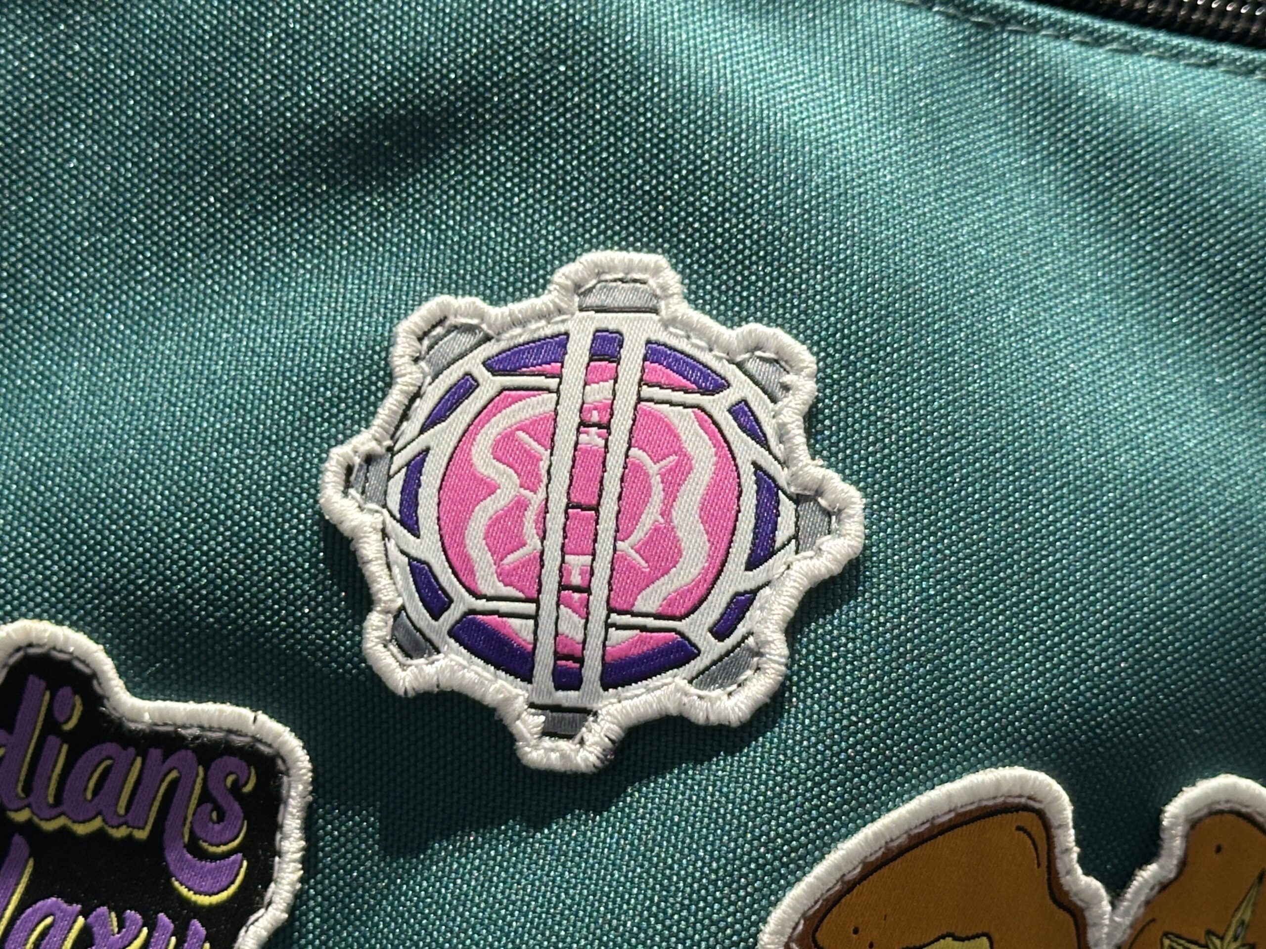 Patches on the front pocket depict toast with butter in the shape of the Nova Corps logo, the Cosmic Generator, and the same artwork from the purple sweatshirt.