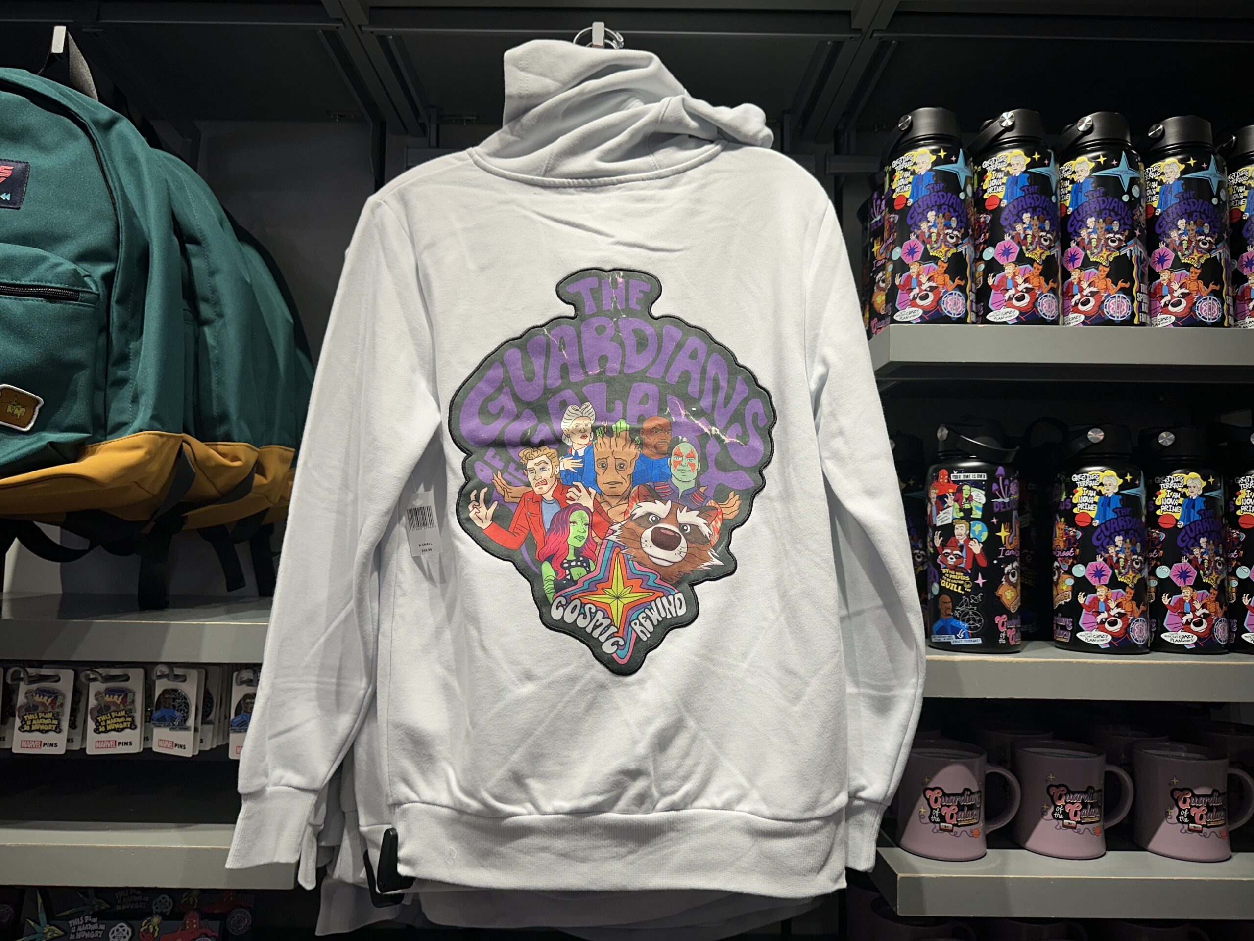 On the back is colorful artwork reminiscent of classic Scooby Doo cartoons. The Guardians are pictured, along with Nova Prime Irani Rael and Centurion Tal Marik. "The Guardians of the Galaxy" is in purple bubble lettering while "Cosmic Rewind" is in white around a rainbow Nova Corps logo.