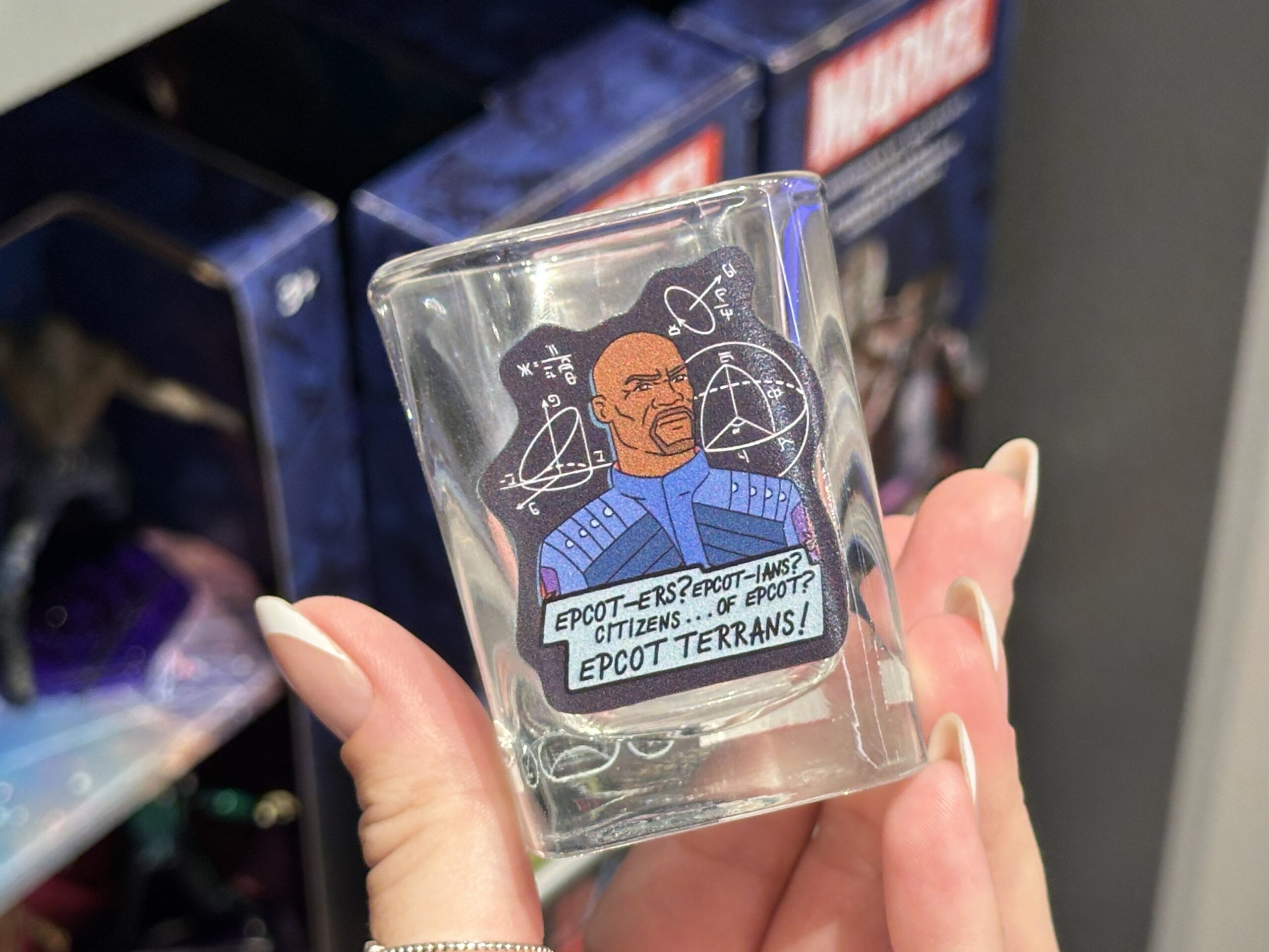 "Guardians of the Galaxy: Cosmic Rewind" is on one side of this squared glass. Tal Marik is on the reverse with geometric diagrams around him and his "EPCOT-ers?" quote below.