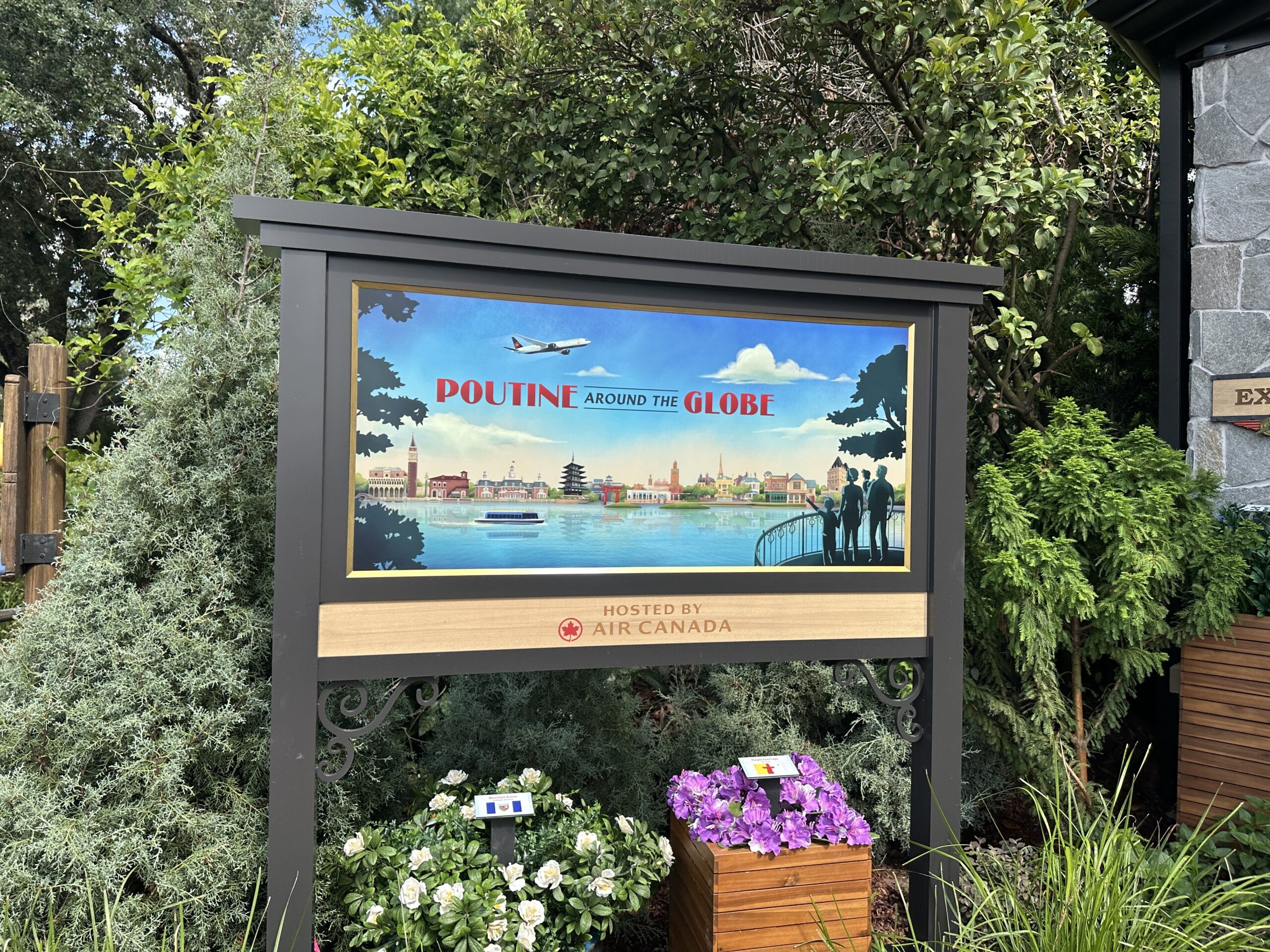 One sign advertises "Poutine Around the Globe," with artwork of a plane flying over World Showcase. A sign on the other side of the features travel-style posters featuring poutine and the Canada pavilion's Hotel du Canada.