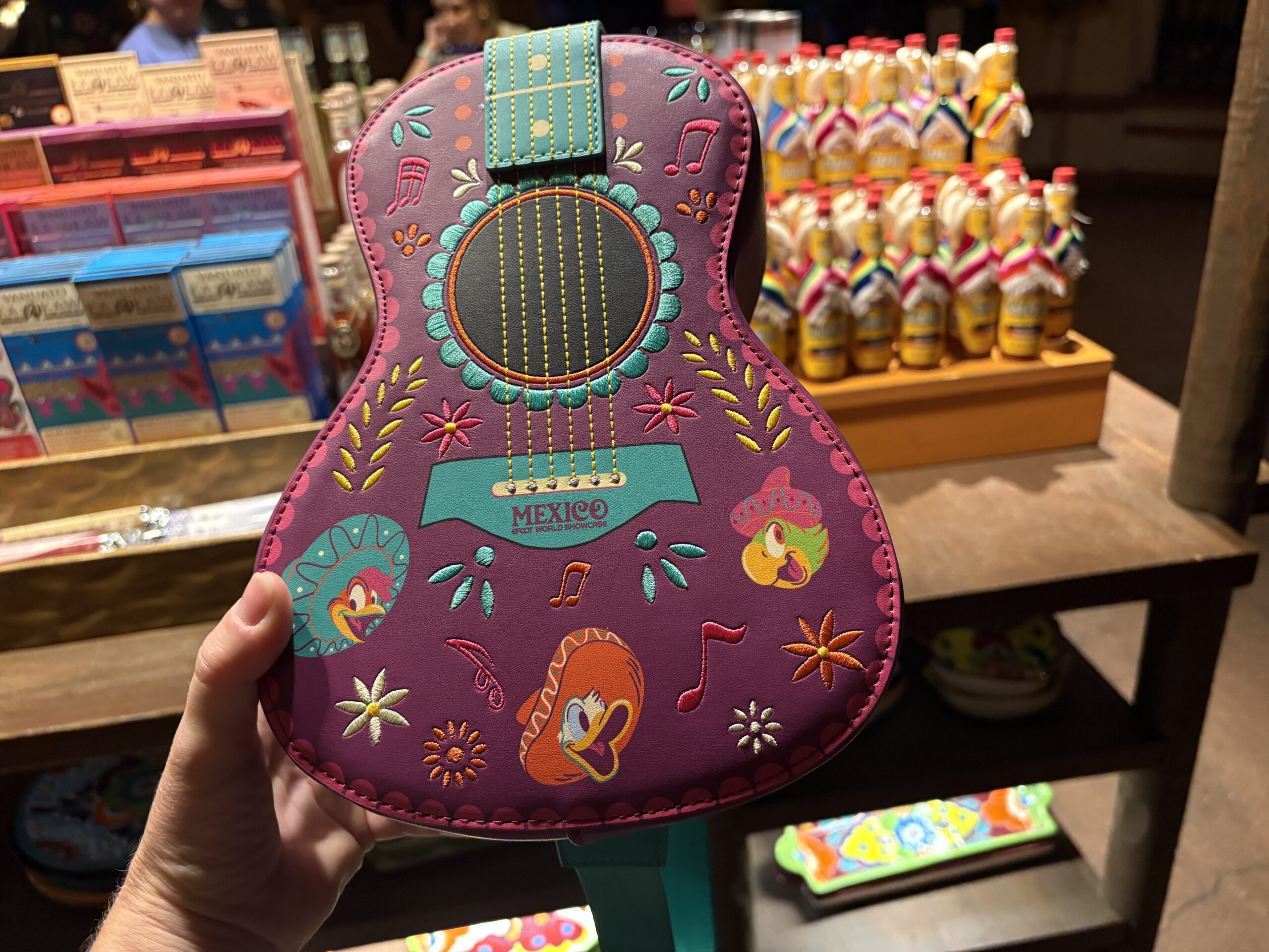 A guitar-shaped Loungefly crossbody bag featuring the Three Caballeros has arrived at EPCOT. We spotted it in Plaza de Los Amigos in the Mexico pavilion.