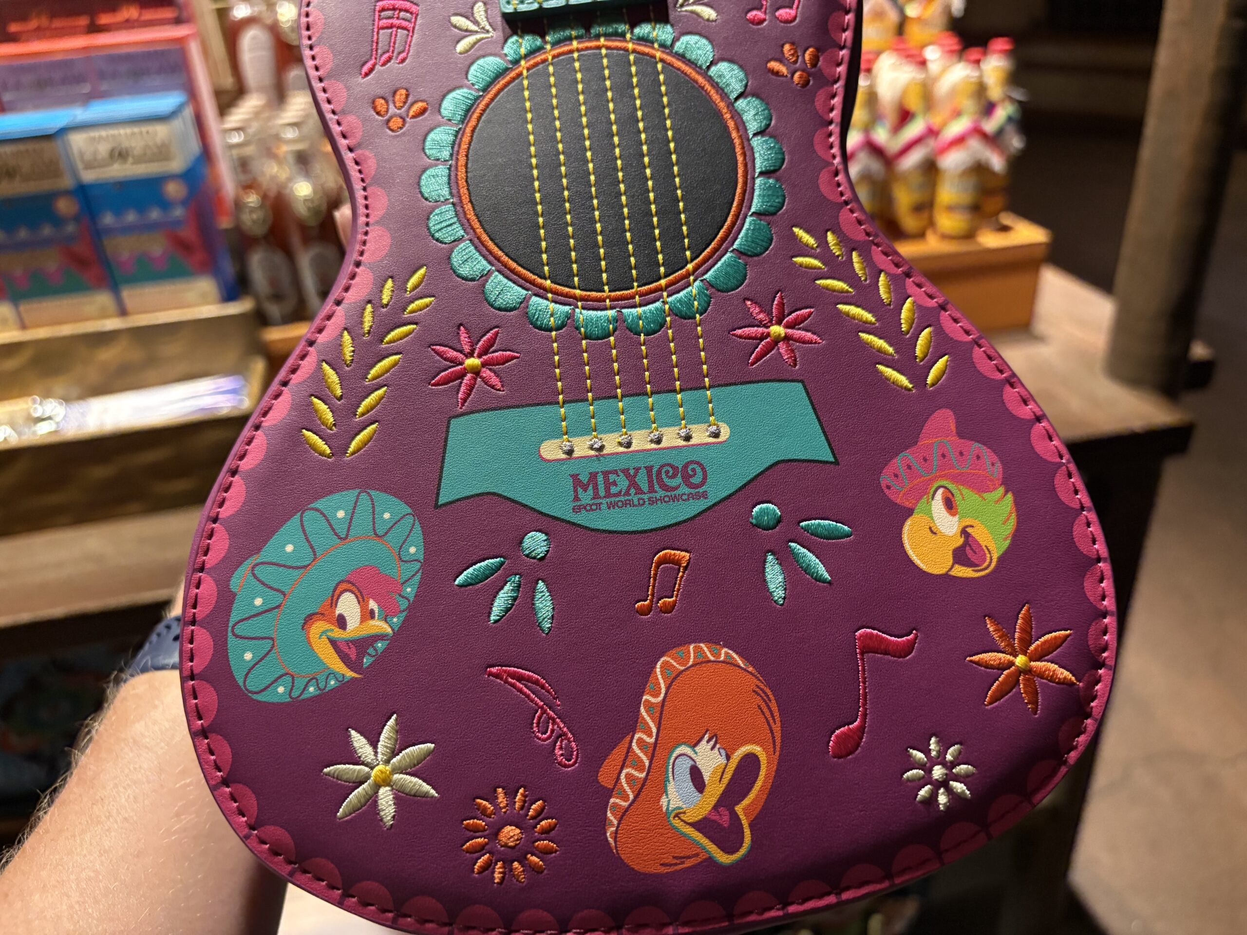 A guitar-shaped Loungefly crossbody bag featuring the Three Caballeros has arrived at EPCOT. We spotted it in Plaza de Los Amigos in the Mexico pavilion.