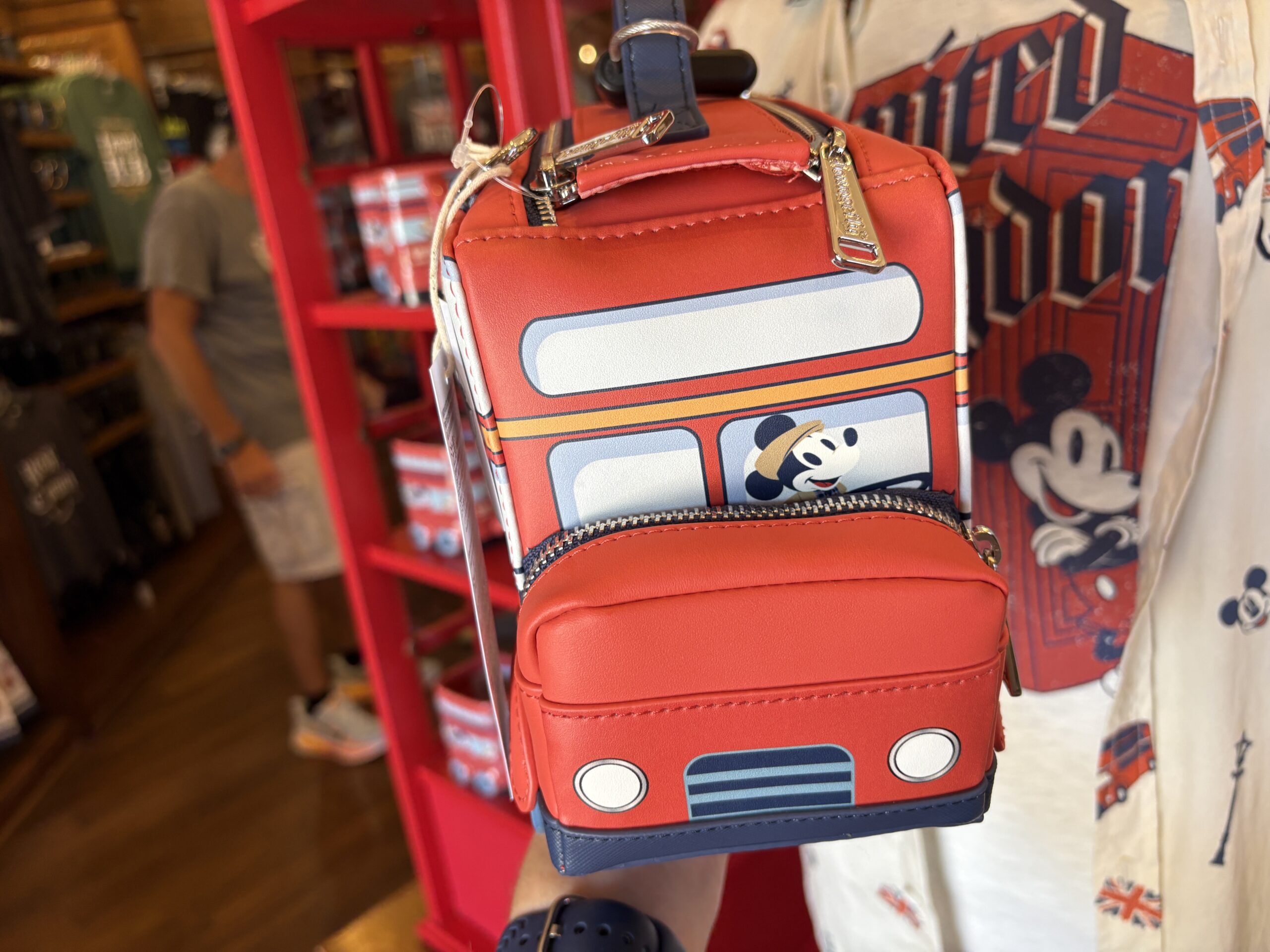 The front of the bus is a small zip pouch. On the back is the Disney Parks | Loungefly label plate.