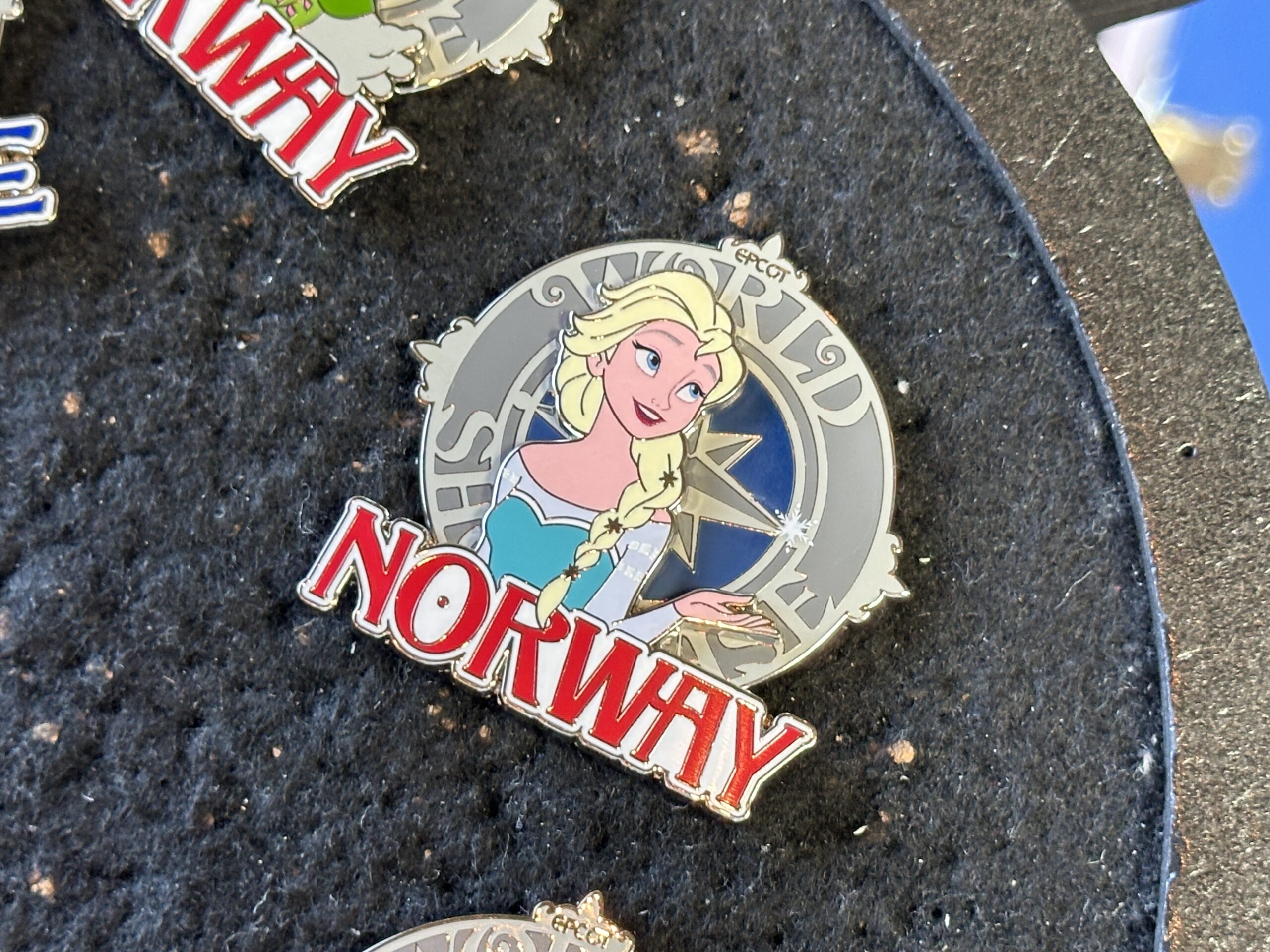 The first of two Norway pins features Elsa in her iconic Ice Queen outfit, summoning a snowflake.