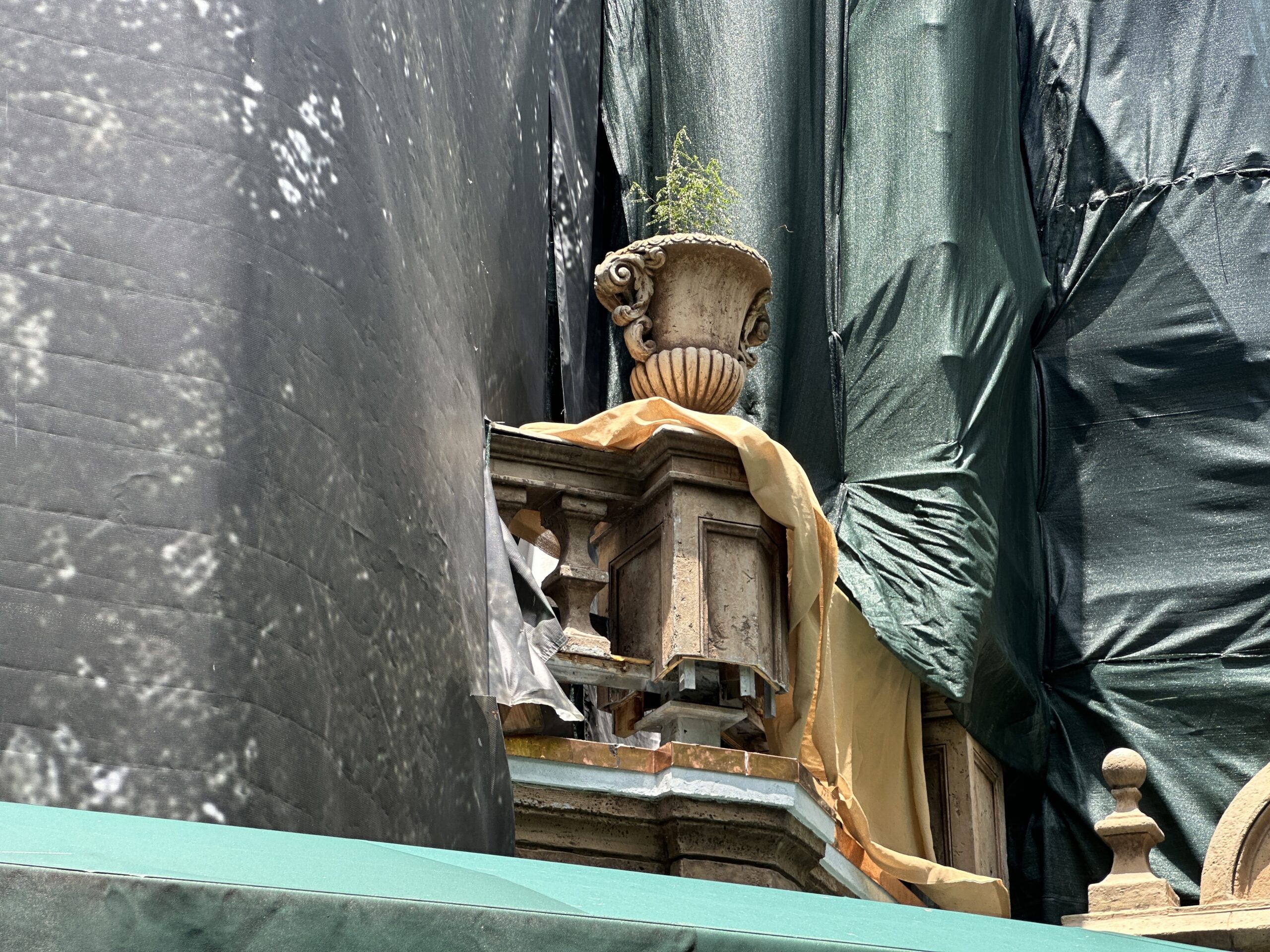 The stone elements around the building, like the banister and flower pot seen above, also appear to be lighter now. This also points to the color schemes the attraction had in its early years.