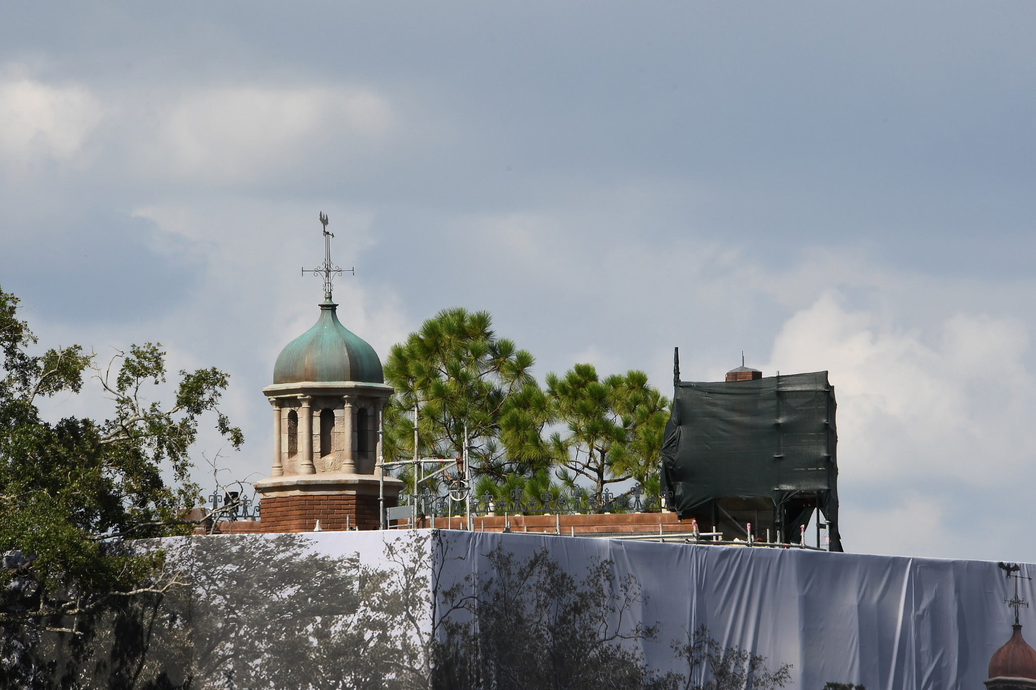 Now that the scrim is starting to come down around the Haunted Mansion, we can see a handful of the changes that have been made during the refurbishment. Starting at the top, the cupola dome is back to its green finish, as it had upon opening in 1971. The bricks are also darker.